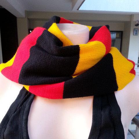 Handwoven multi-colored neck scarf showcasing a classic ribbed stitch design, perfect for winter wear.