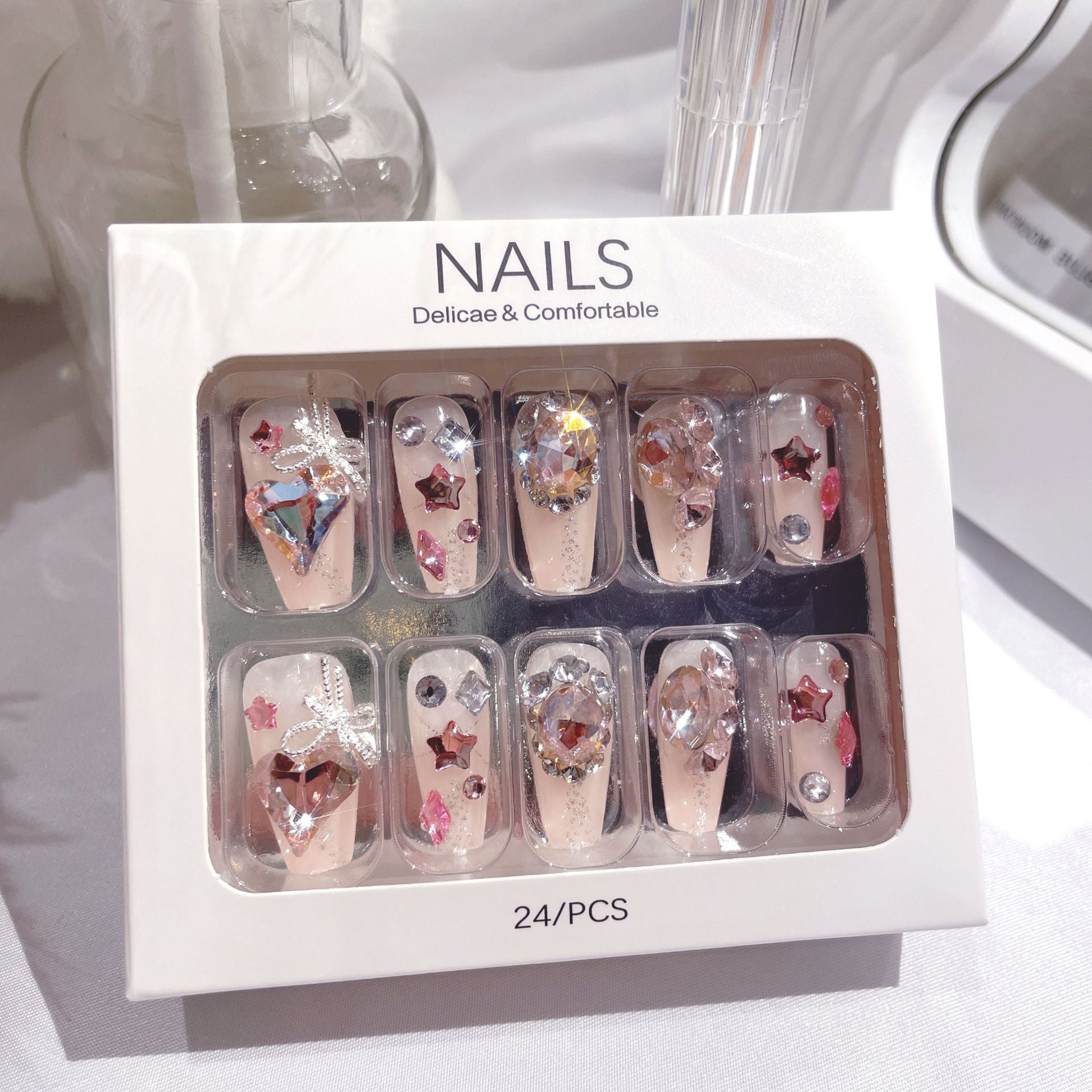 A set of 24 sparkling gem fake nails displayed in an elegant arrangement, showcasing their vibrant colors and dazzling designs.