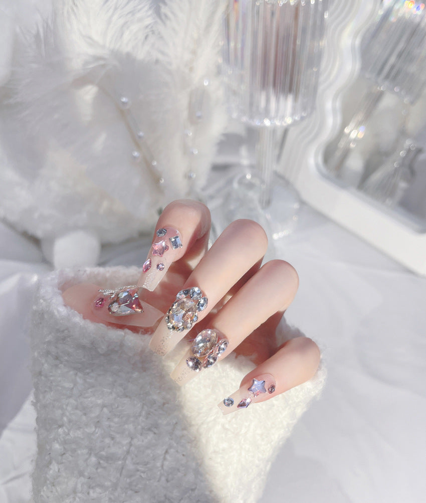 A set of 24 sparkling gem fake nails displayed in an elegant arrangement, showcasing their vibrant colors and dazzling designs.