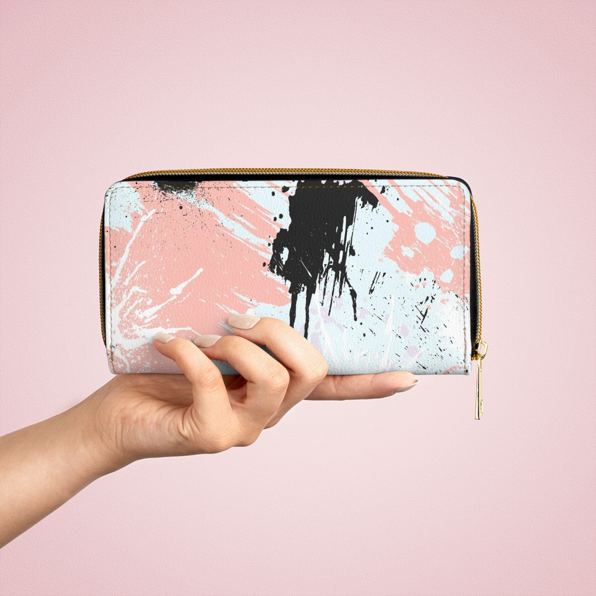 Abstract pink, black, and white paint splatter pattern women's zipper wallet showcasing its stylish design and functional compartments.