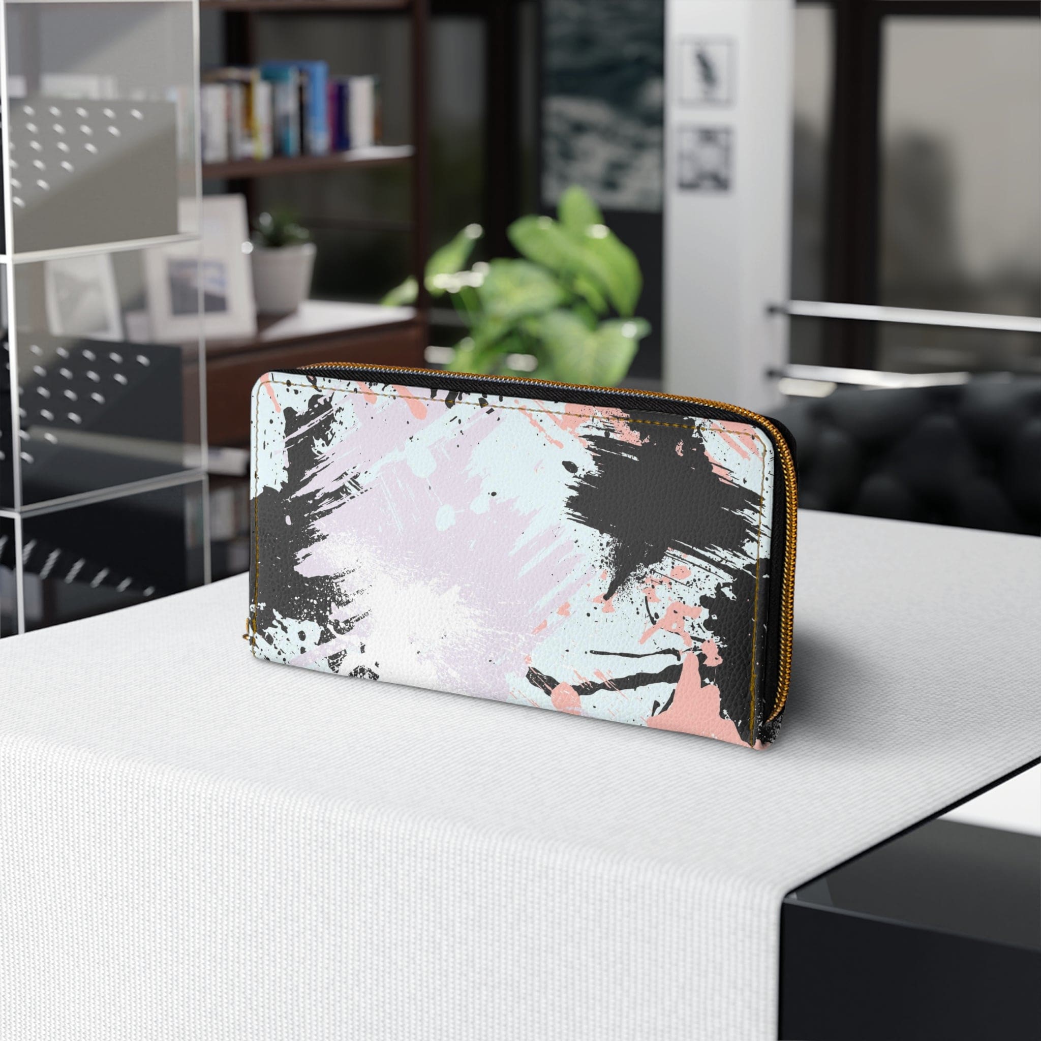 Abstract pink, black, and white paint splatter pattern women's zipper wallet showcasing its stylish design and functional compartments.