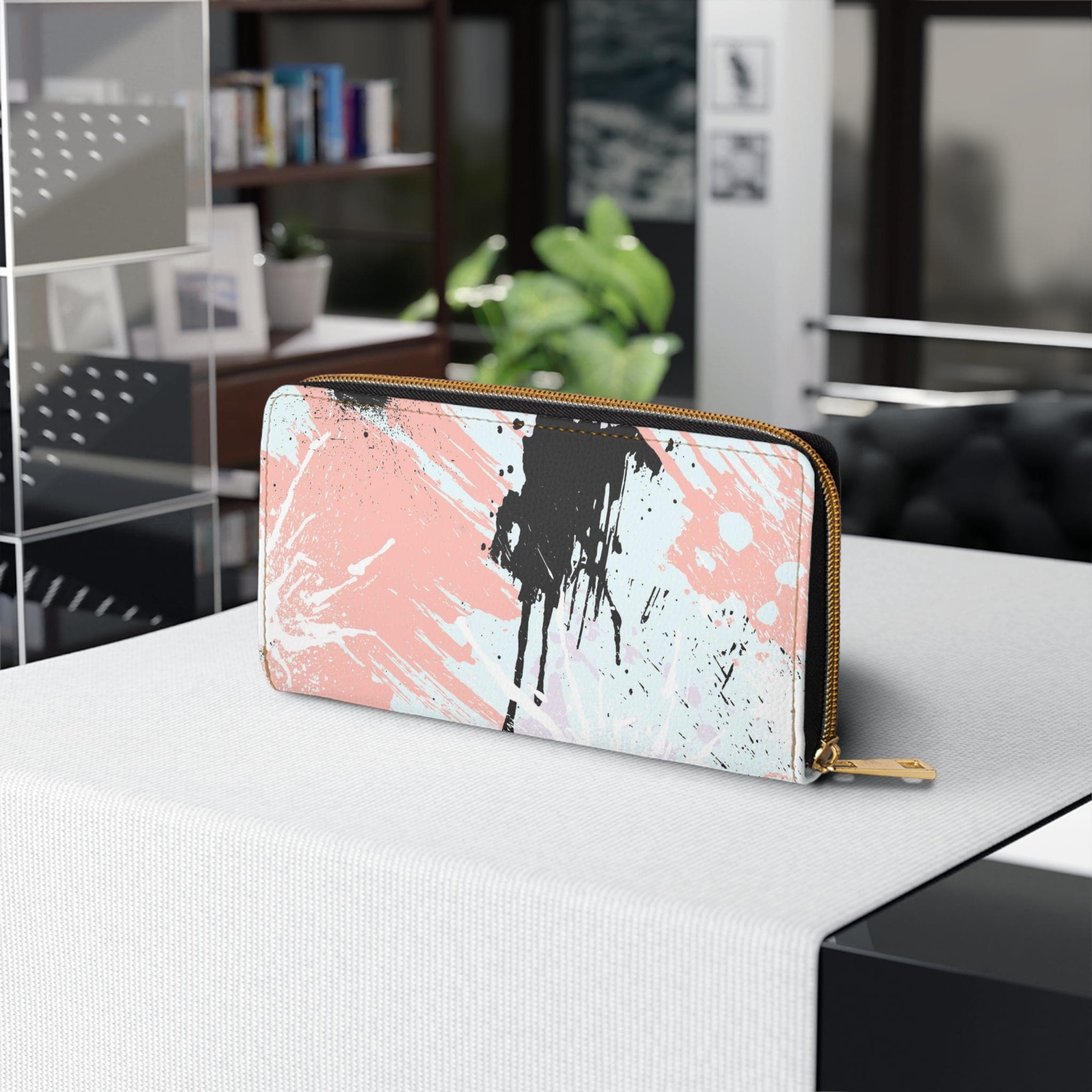 Abstract pink, black, and white paint splatter pattern women's zipper wallet showcasing its stylish design and functional compartments.