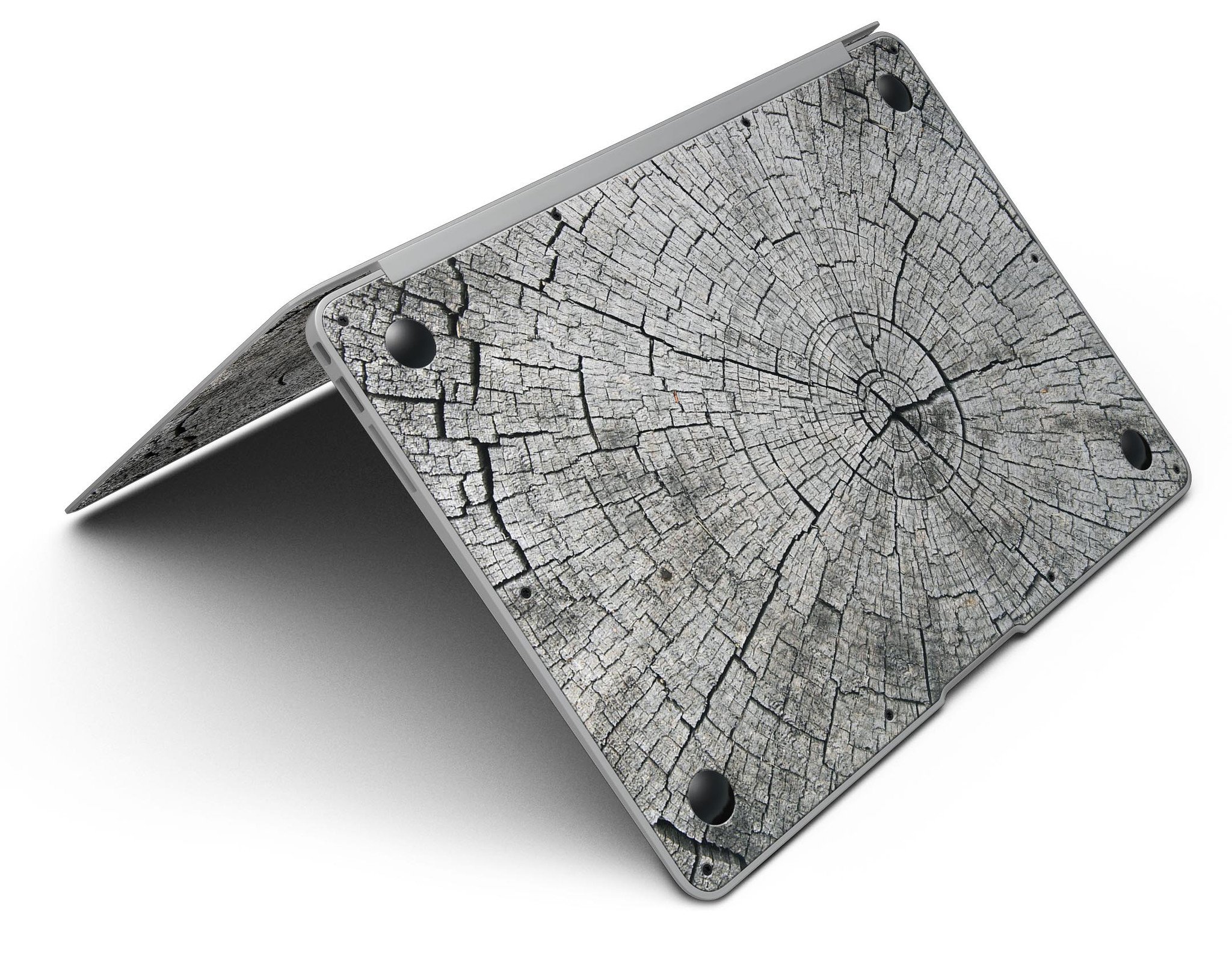 Aged Cracked Tree Stump Core skin applied on a MacBook Air, showcasing its unique design and texture.