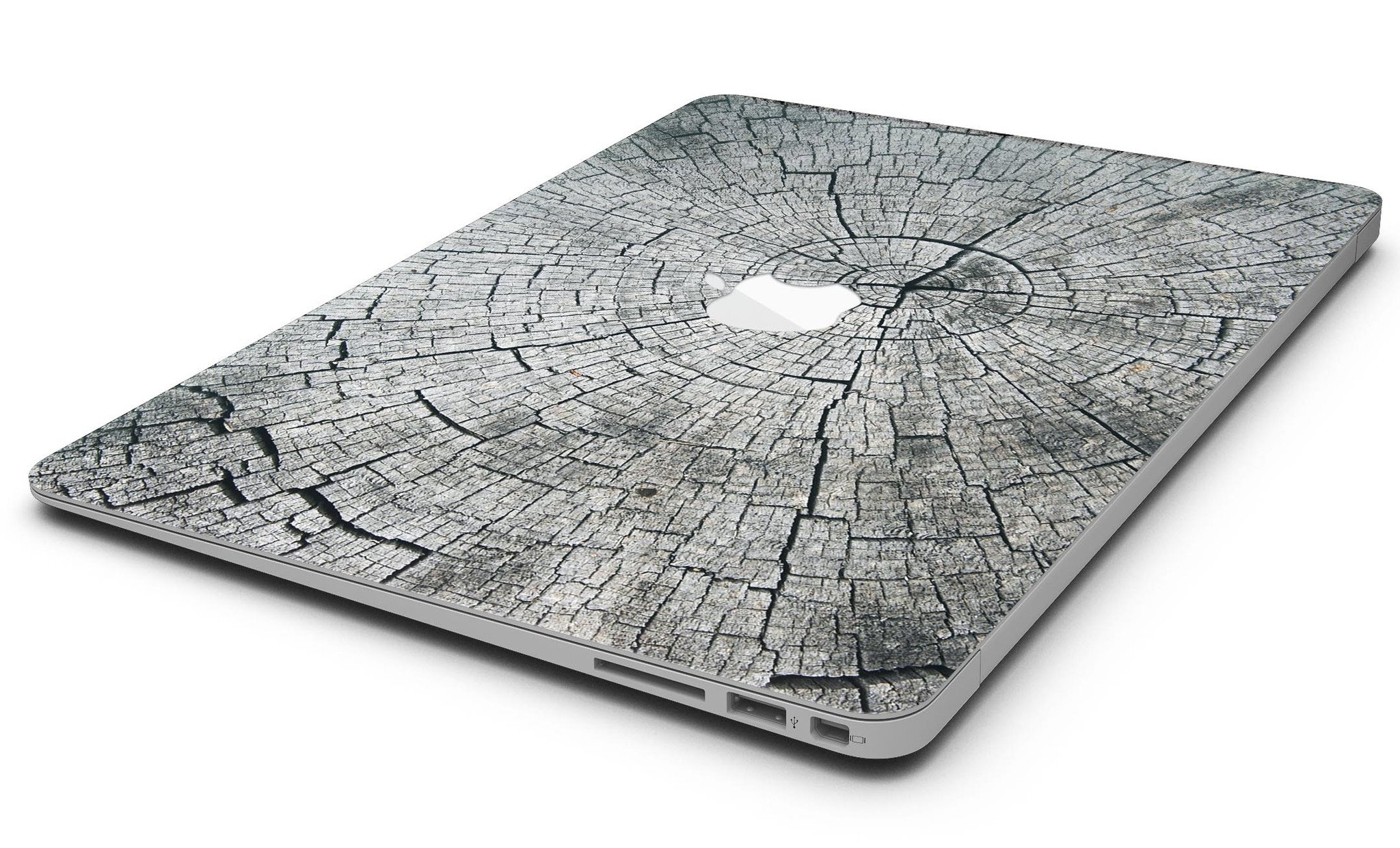 Aged Cracked Tree Stump Core skin applied on a MacBook Air, showcasing its unique design and texture.