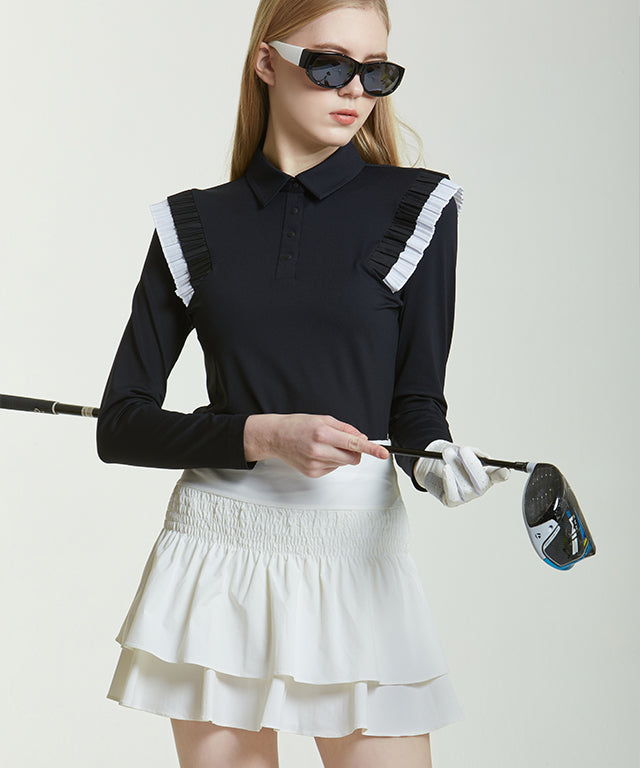 Anna Smock Pleated Skirt in O/White featuring a two-tiered design with smoking flares and a high waist for a flattering silhouette.