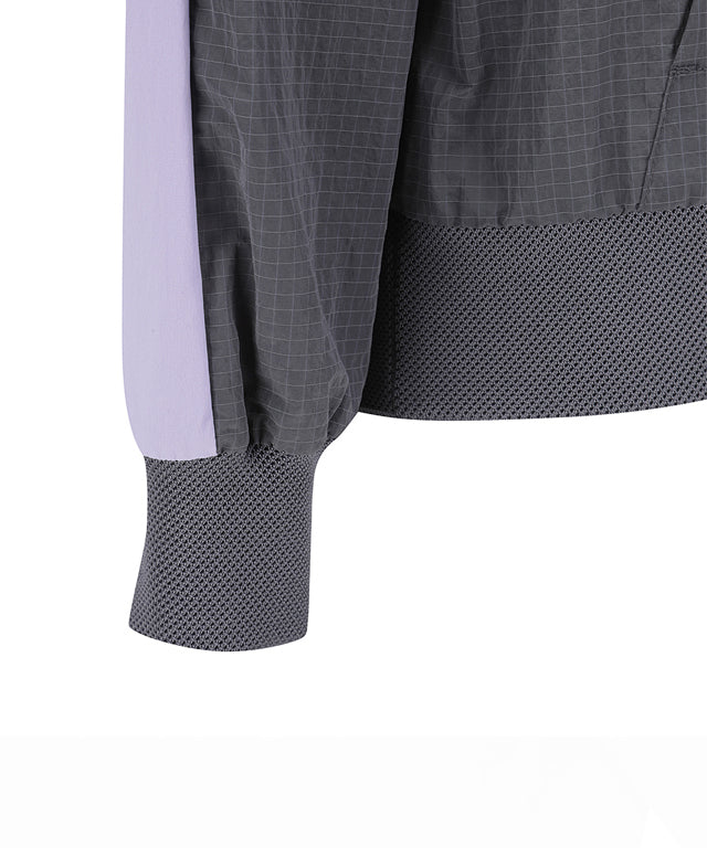 ANEW Golf Women Ribbed Color Block Anorak in Charcoal Gray with lavender accents, showcasing a stylish and functional design.