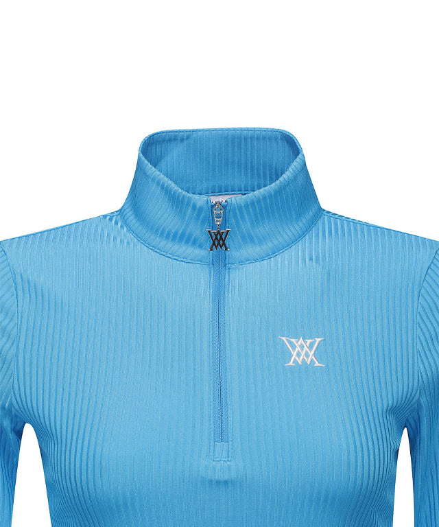 Light blue women's long t-shirt with zipper and ribbed design, perfect for golf and casual wear.