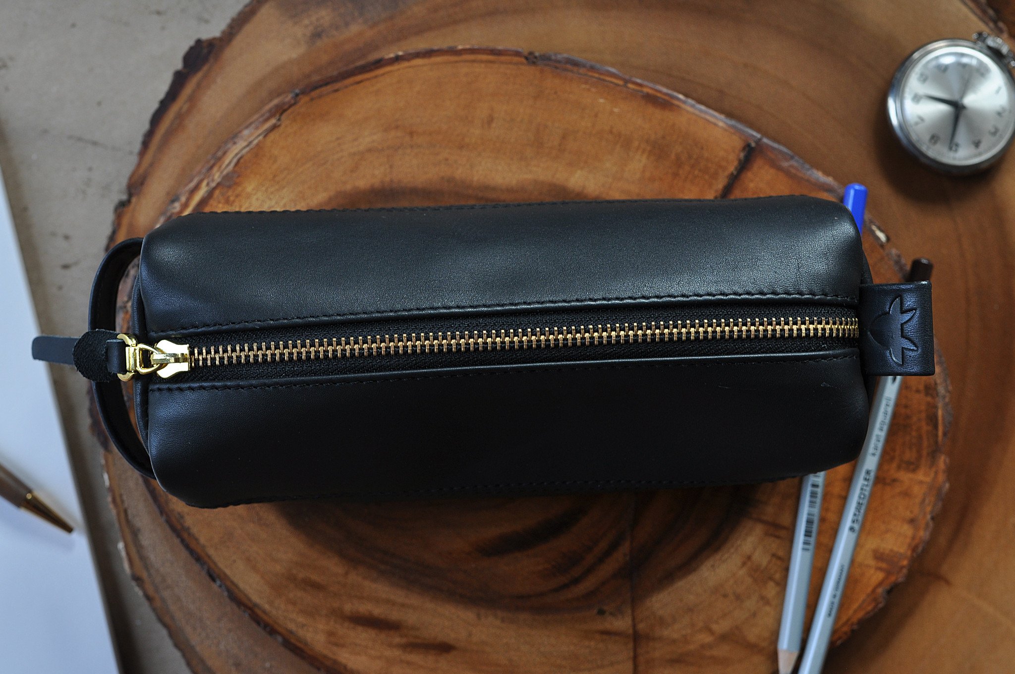 Leather Assortment Pack featuring premium black leather, gold zipper, and checkered lining, ideal for stationery and knick-knacks.