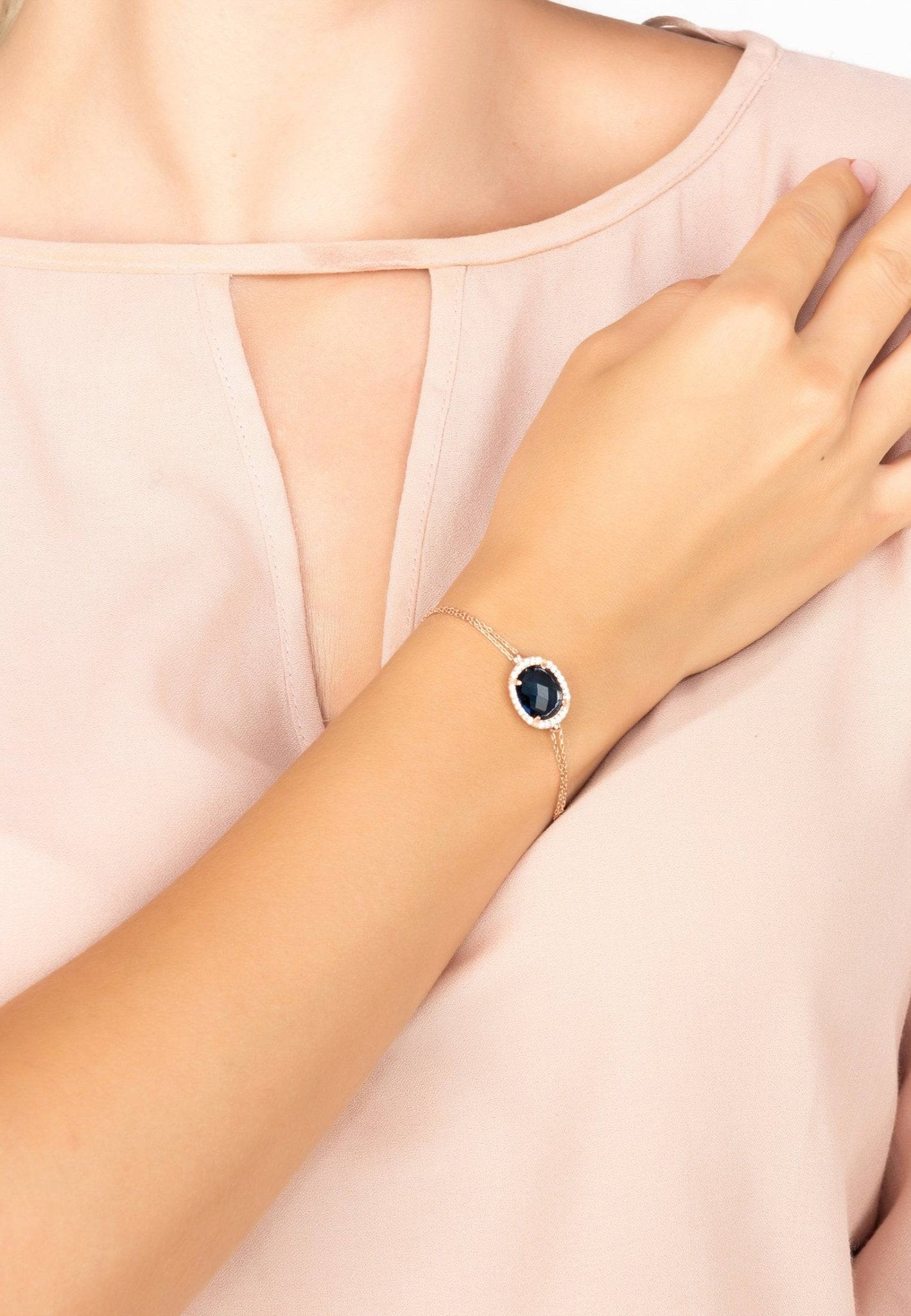 Beatrice Oval Gemstone Bracelet in rose gold featuring a hydro sapphire and cubic zirconia details, showcasing elegance and luxury.