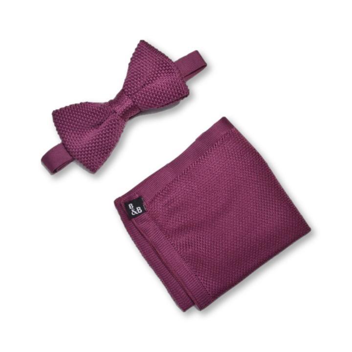 Berry pink knitted bow tie and matching pocket square set displayed elegantly.