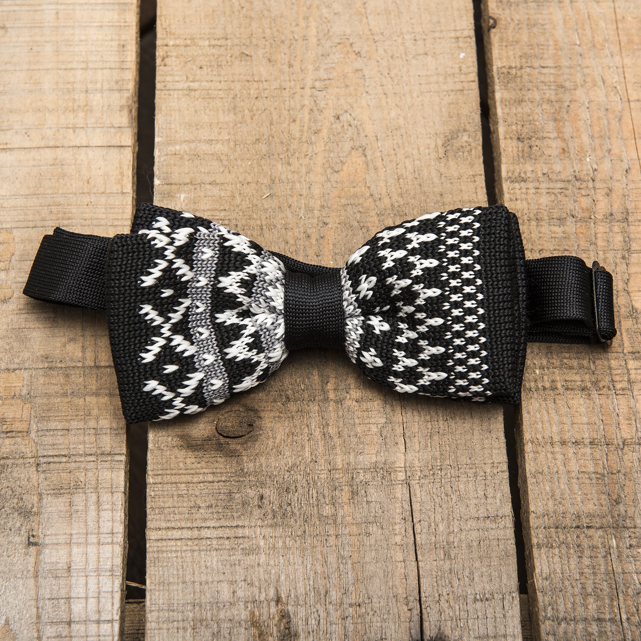 A stylish black and white patterned knitted bow tie, showcasing its unique design and texture.