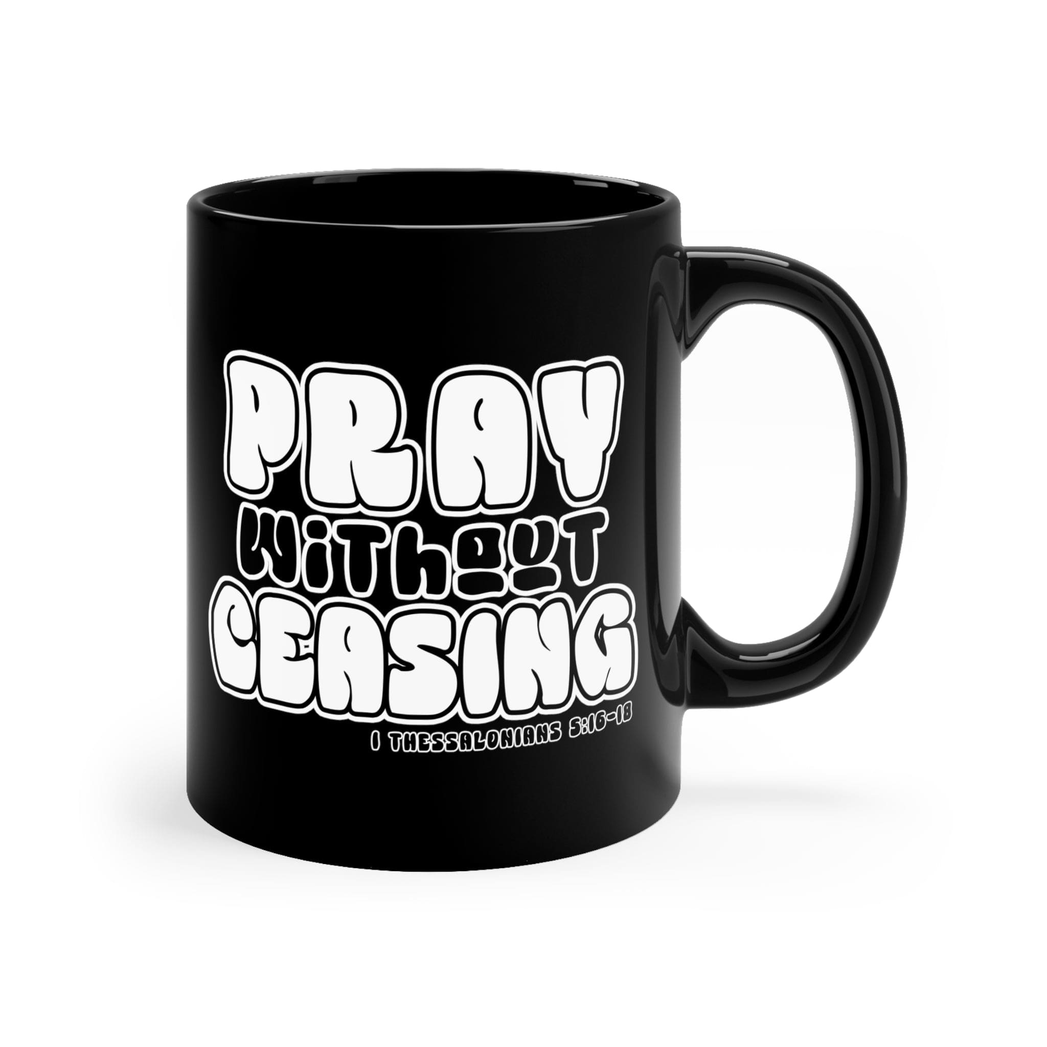 Black ceramic mug with 'Pray Without Ceasing' inspirational design, perfect for coffee or tea.