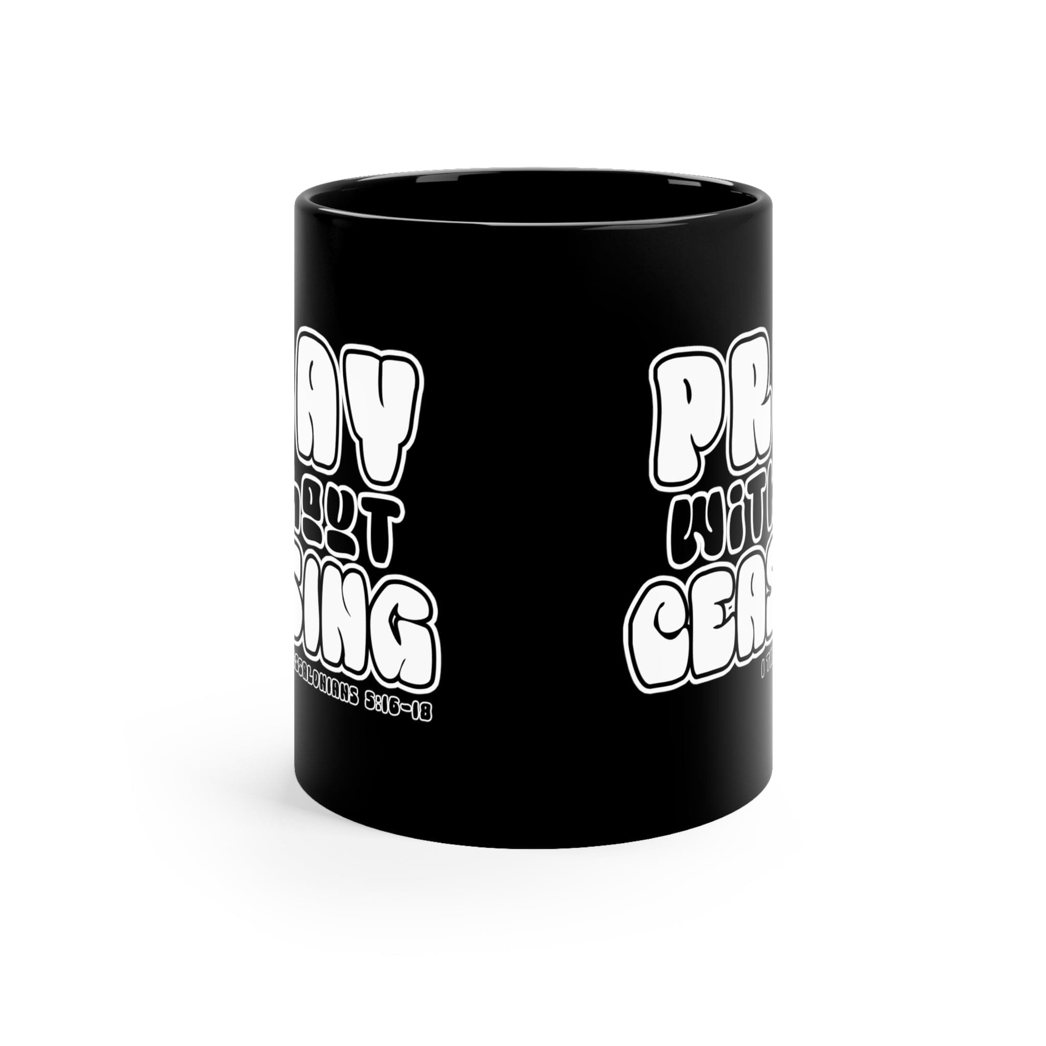 Black ceramic mug with 'Pray Without Ceasing' inspirational design, perfect for coffee or tea.