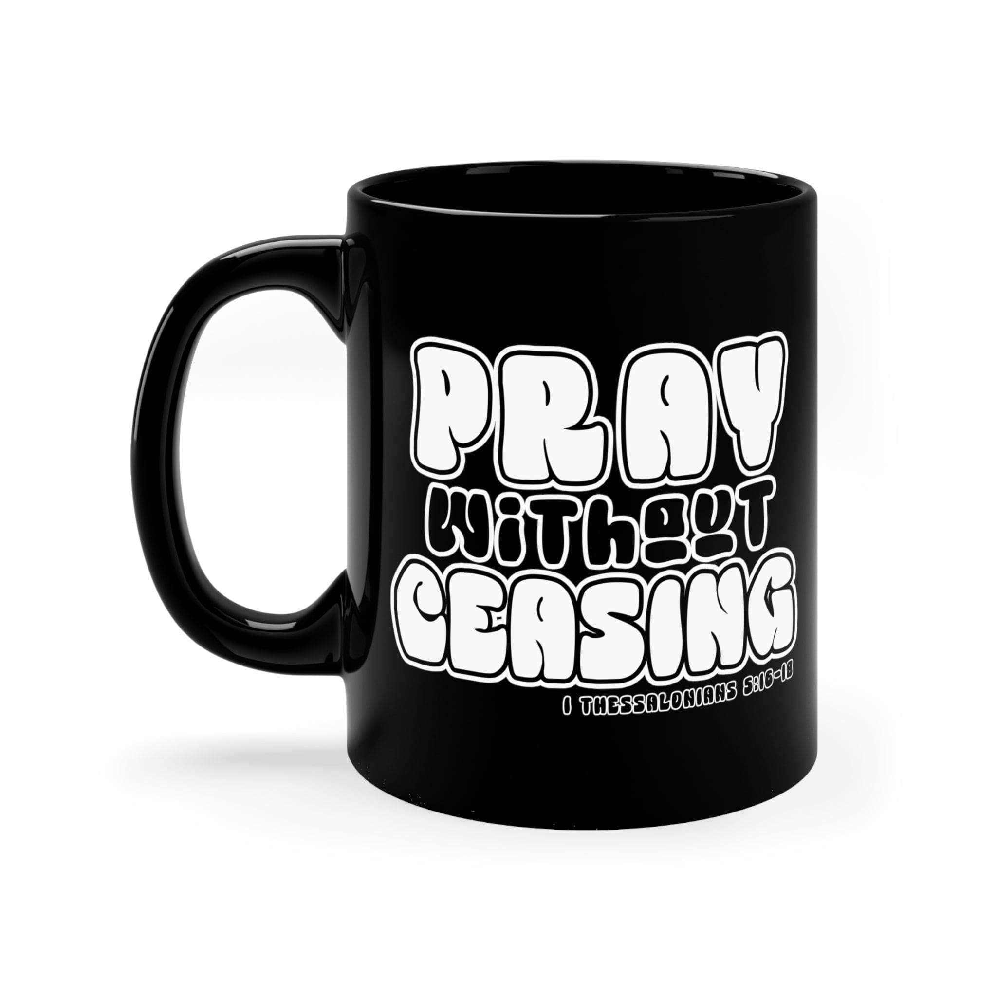 Black ceramic mug with 'Pray Without Ceasing' inspirational design, perfect for coffee or tea.