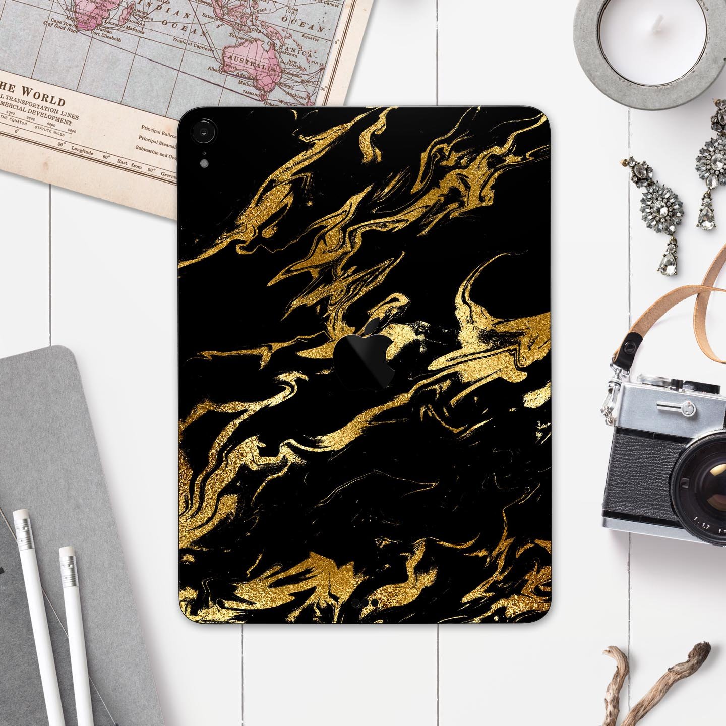 Black and gold marble swirl skin decal for Apple devices, showcasing a stylish design with premium finish.