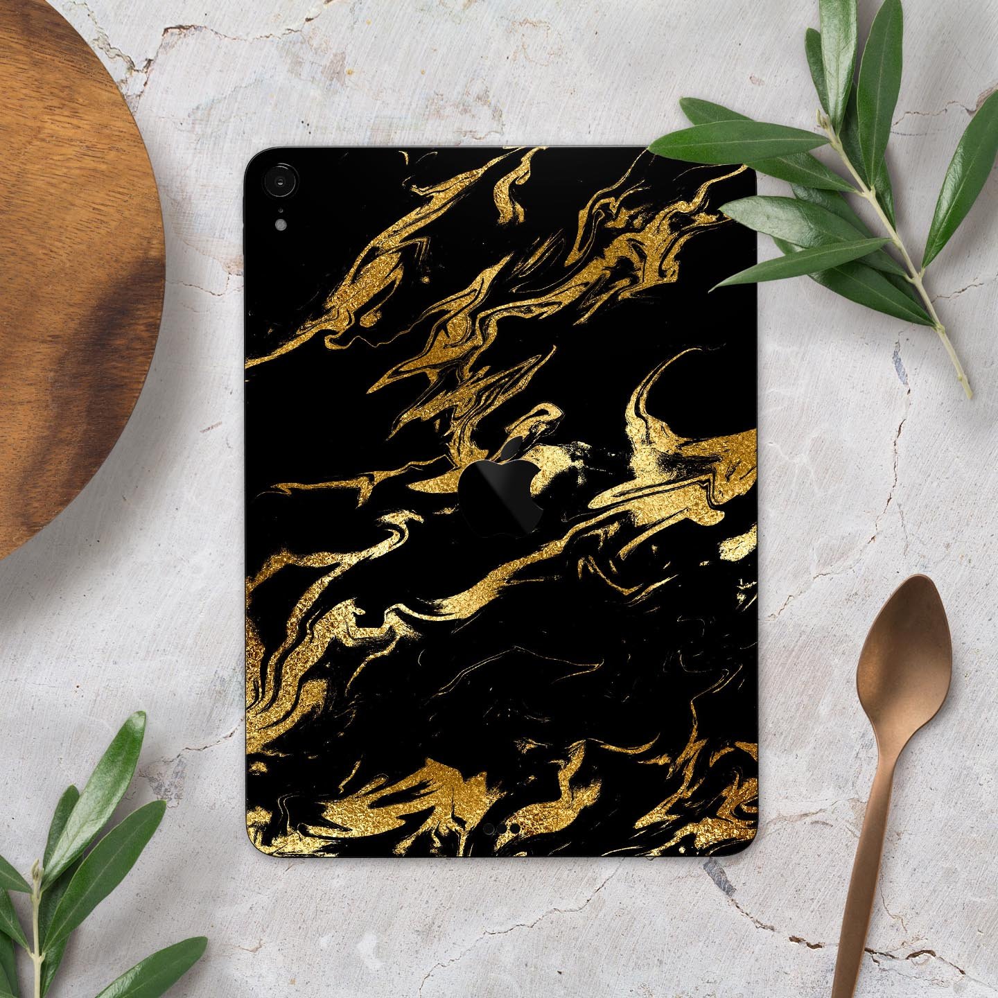 Black and gold marble swirl skin decal for Apple devices, showcasing a stylish design with premium finish.