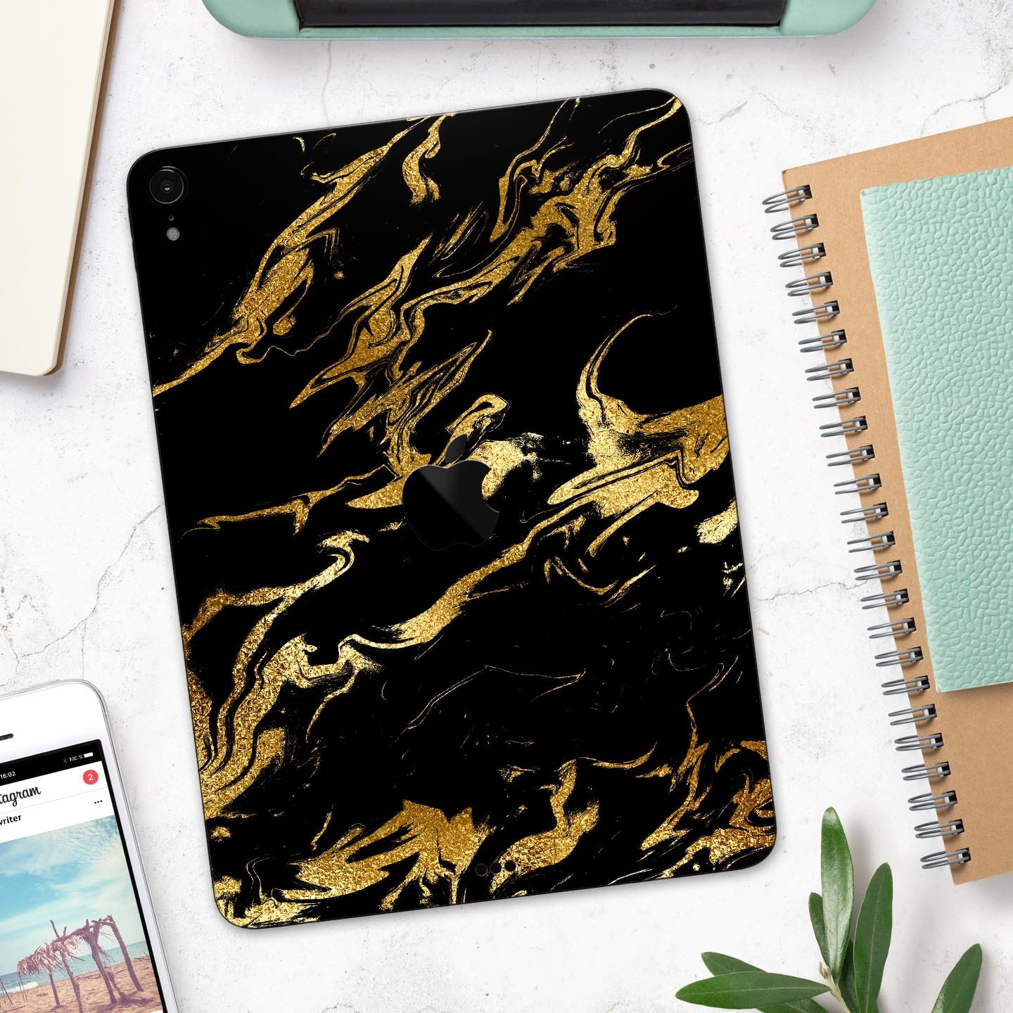 Black and gold marble swirl skin decal for Apple devices, showcasing a stylish design with premium finish.