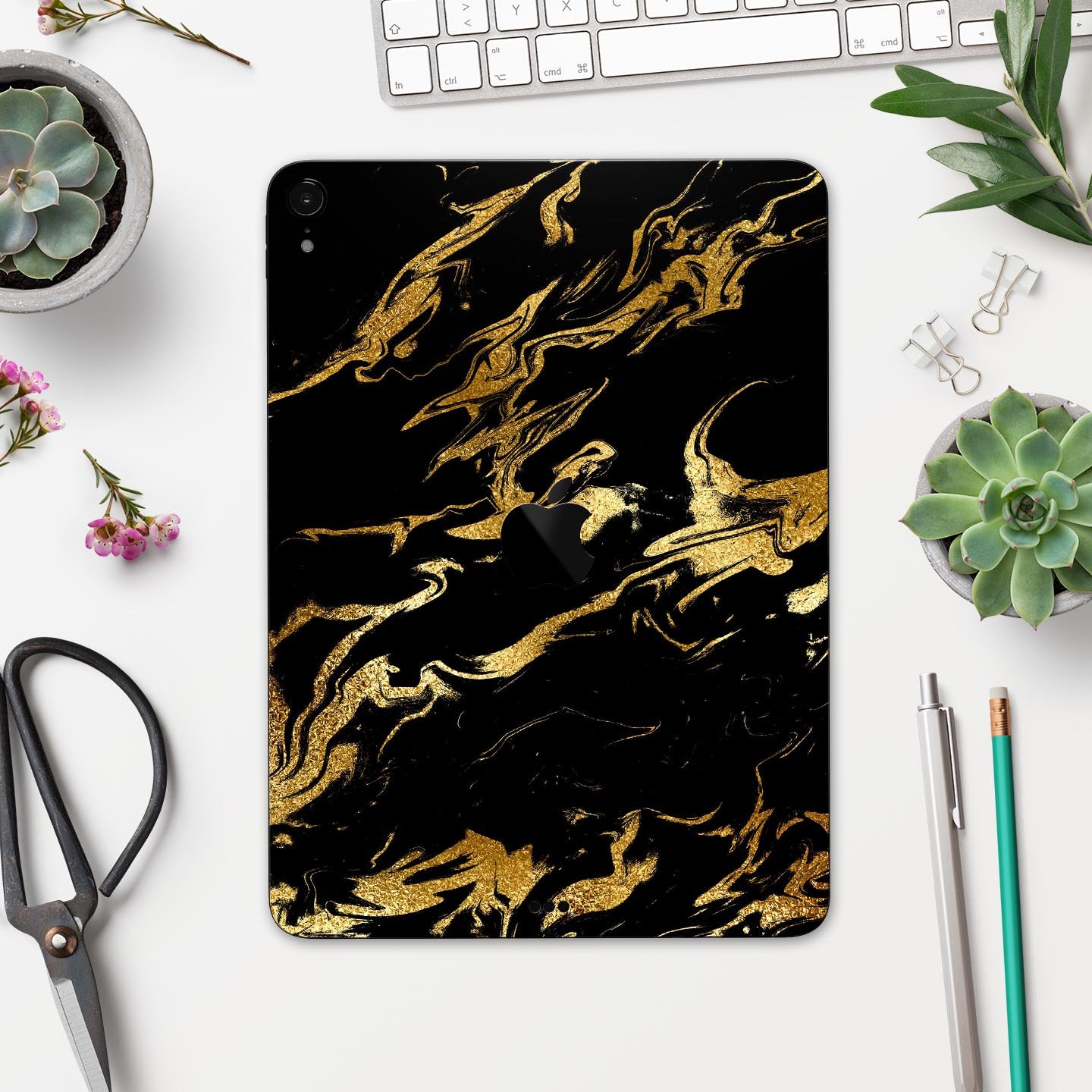 Black and gold marble swirl skin decal for Apple devices, showcasing a stylish design with premium finish.