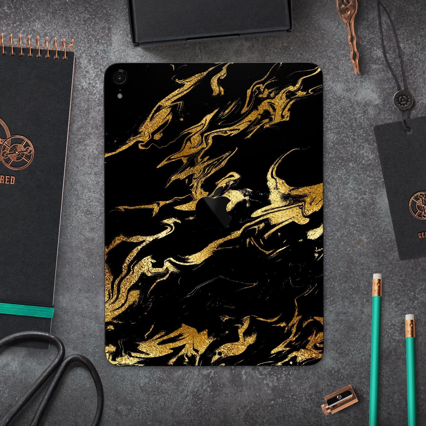 Black and gold marble swirl skin decal for Apple devices, showcasing a stylish design with premium finish.