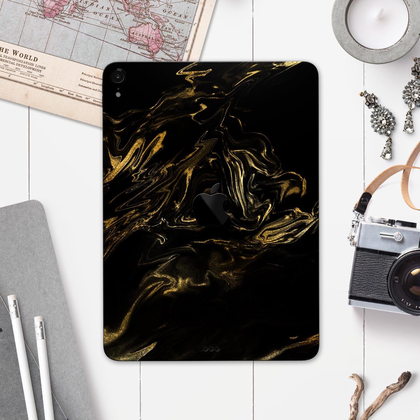 Black and gold marble swirl skin decal for Apple iPad, showcasing a stylish design with premium finish.