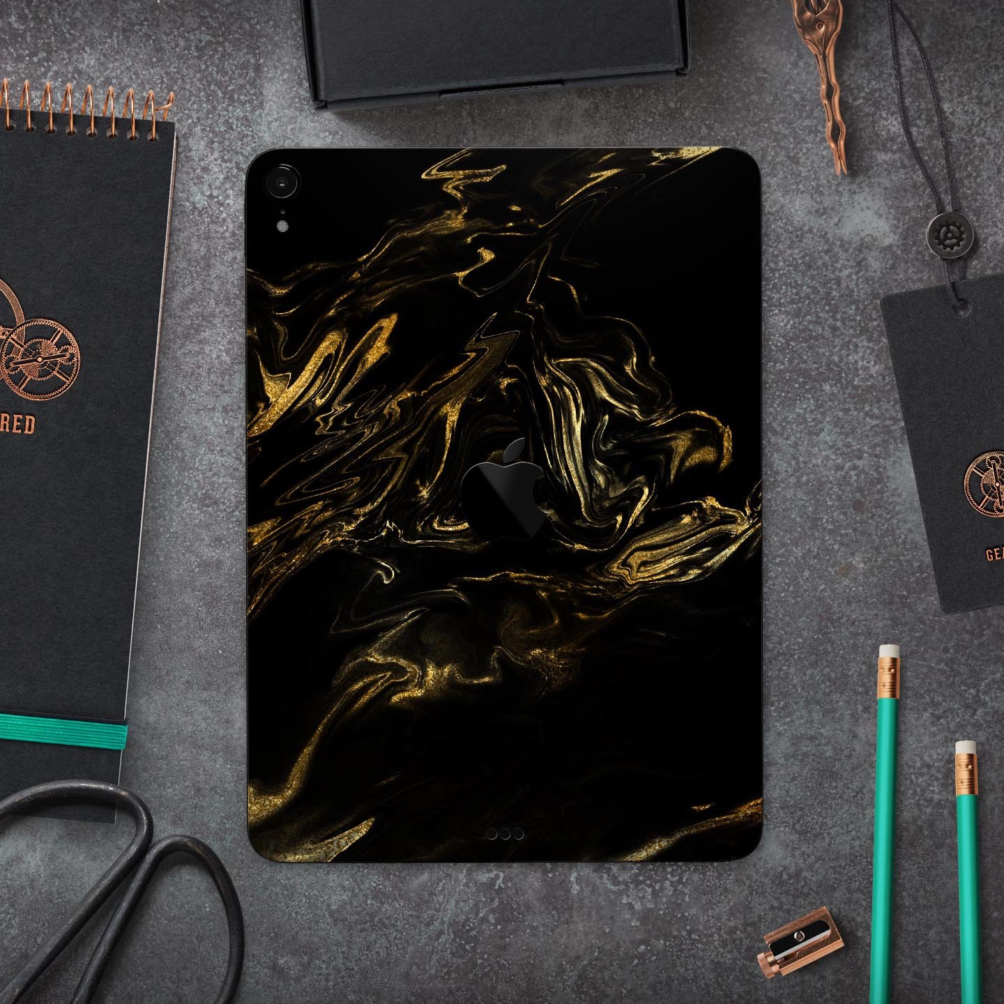Black and gold marble swirl skin decal for Apple iPad, showcasing a stylish design with premium finish.
