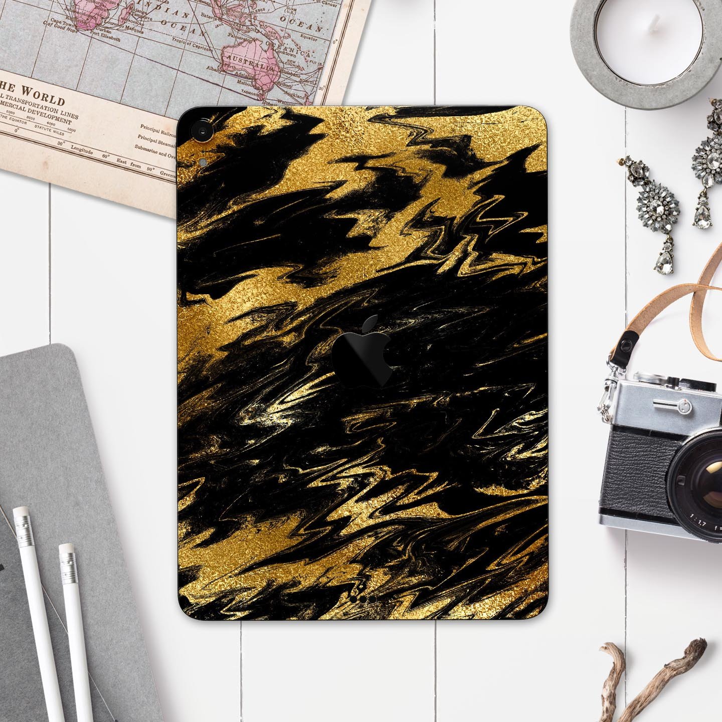 Black and gold marble swirl skin decal for Apple iPad, showcasing elegant design and premium finish.