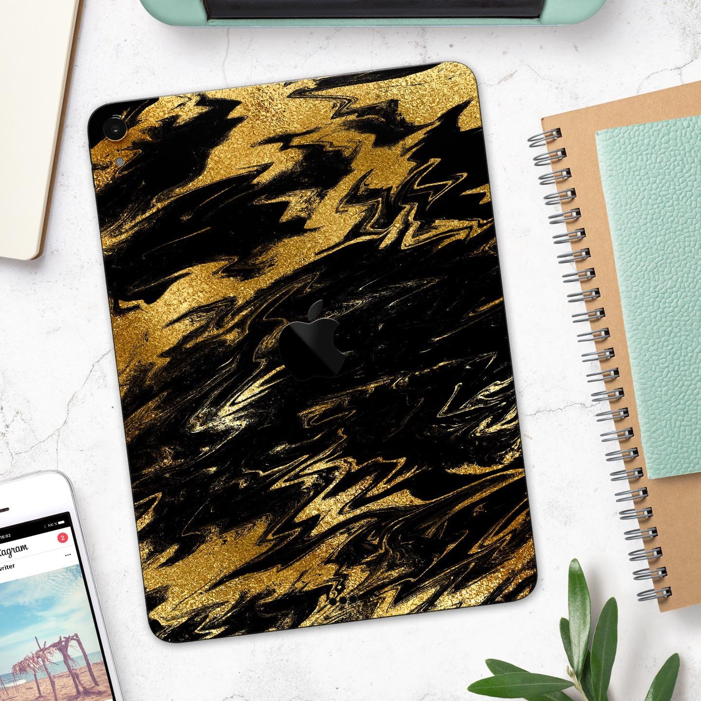 Black and gold marble swirl skin decal for Apple iPad, showcasing elegant design and premium finish.