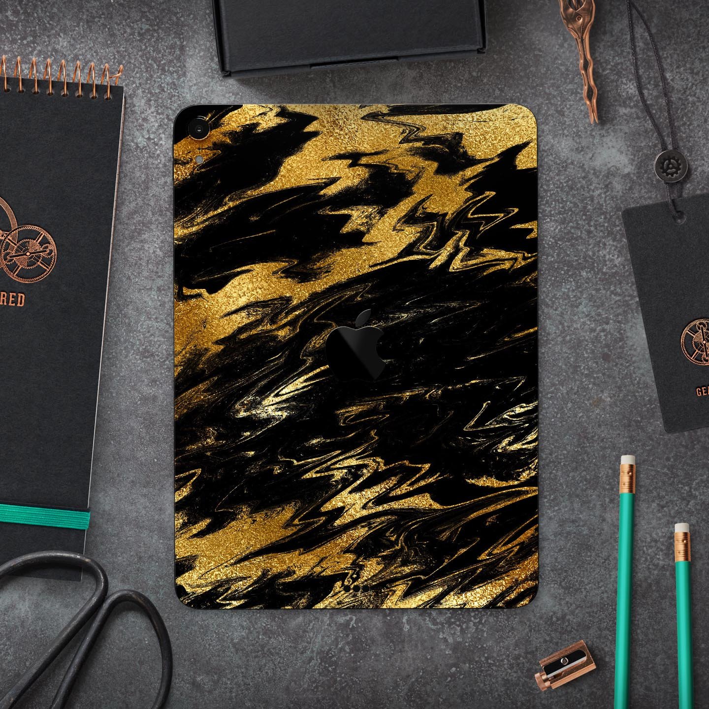 Black and gold marble swirl skin decal for Apple iPad, showcasing elegant design and premium finish.