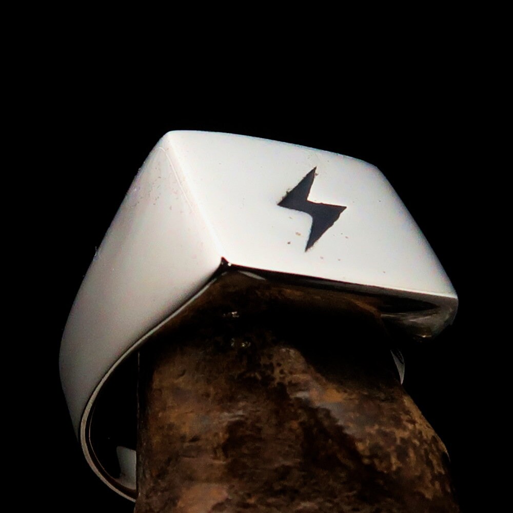 A sleek Black Lightning Ring featuring a square design and lightning bolt motif, crafted from polished sterling silver with black enamel inlay.