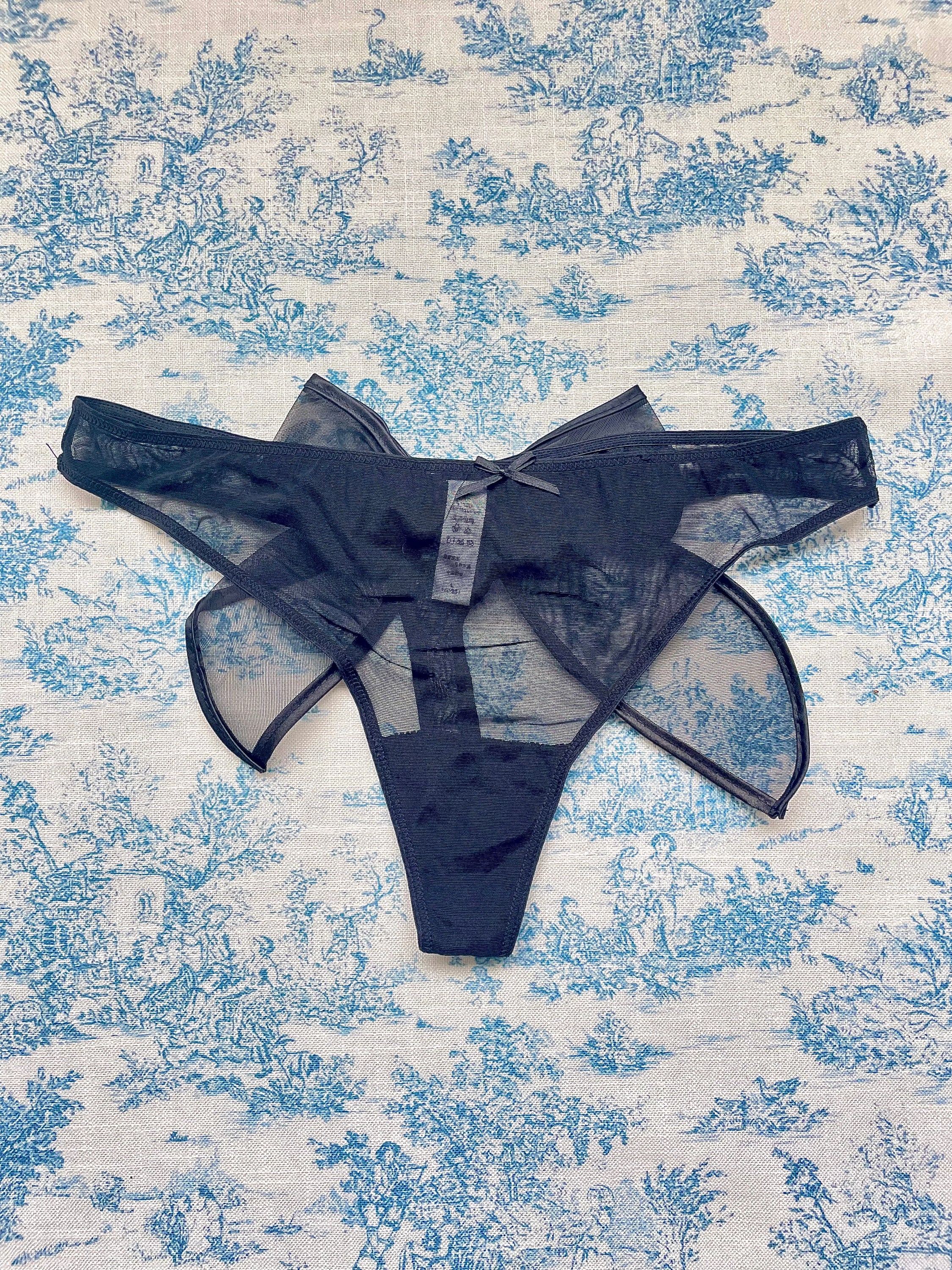 Black Mesh Bow Panty featuring delicate mesh fabric and a luxurious satin bow, perfect for elegant lingerie collections.