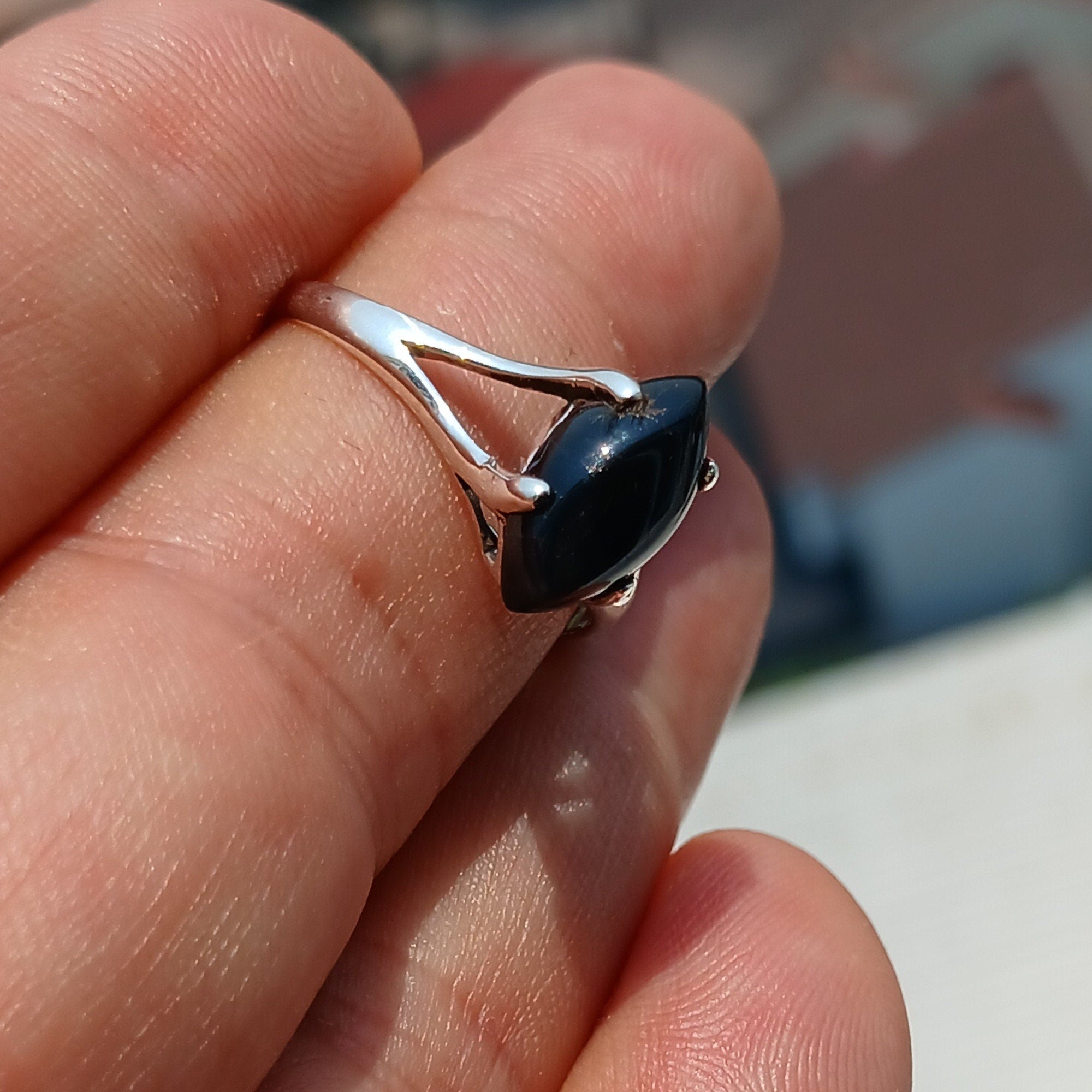 A beautiful Black Onyx Ring featuring a marquise shaped gemstone set in polished sterling silver, showcasing elegance and minimalist design.