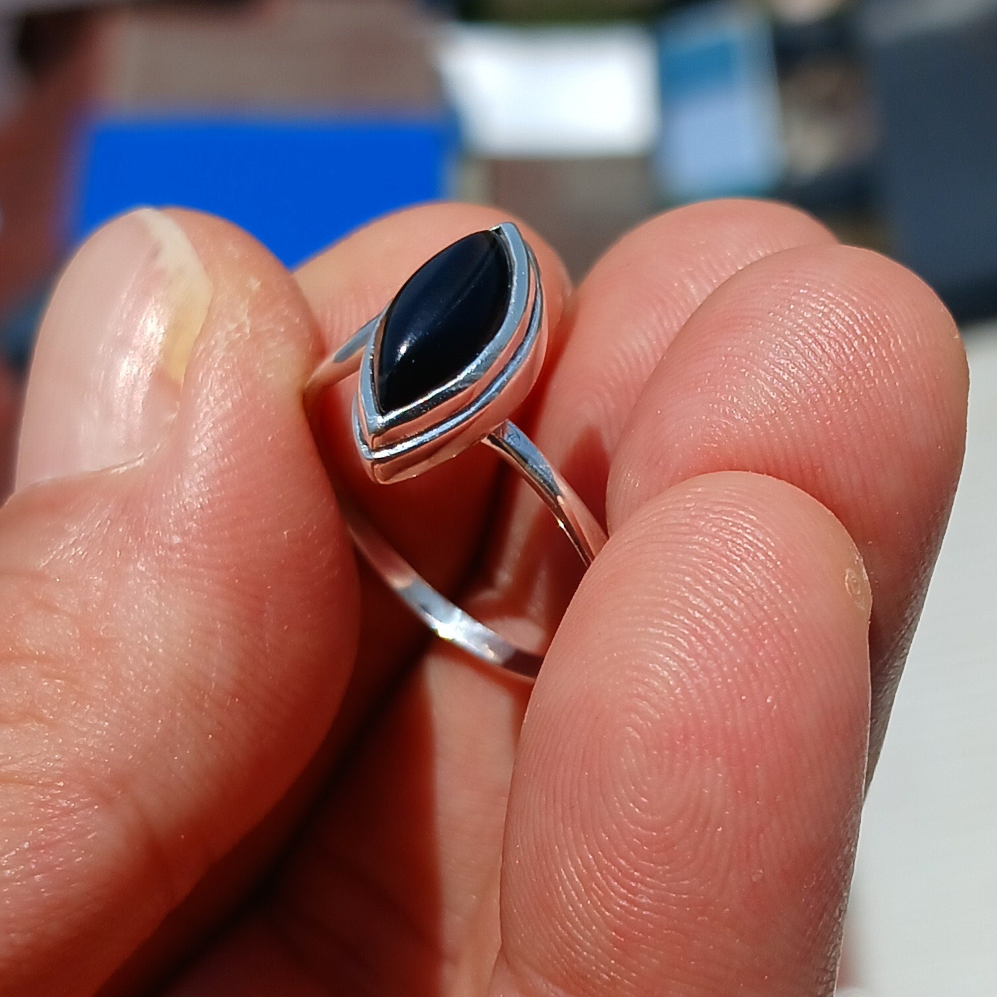 A stunning Black Onyx Ring featuring a marquise shaped gemstone set in polished sterling silver, showcasing elegance and minimalist design.