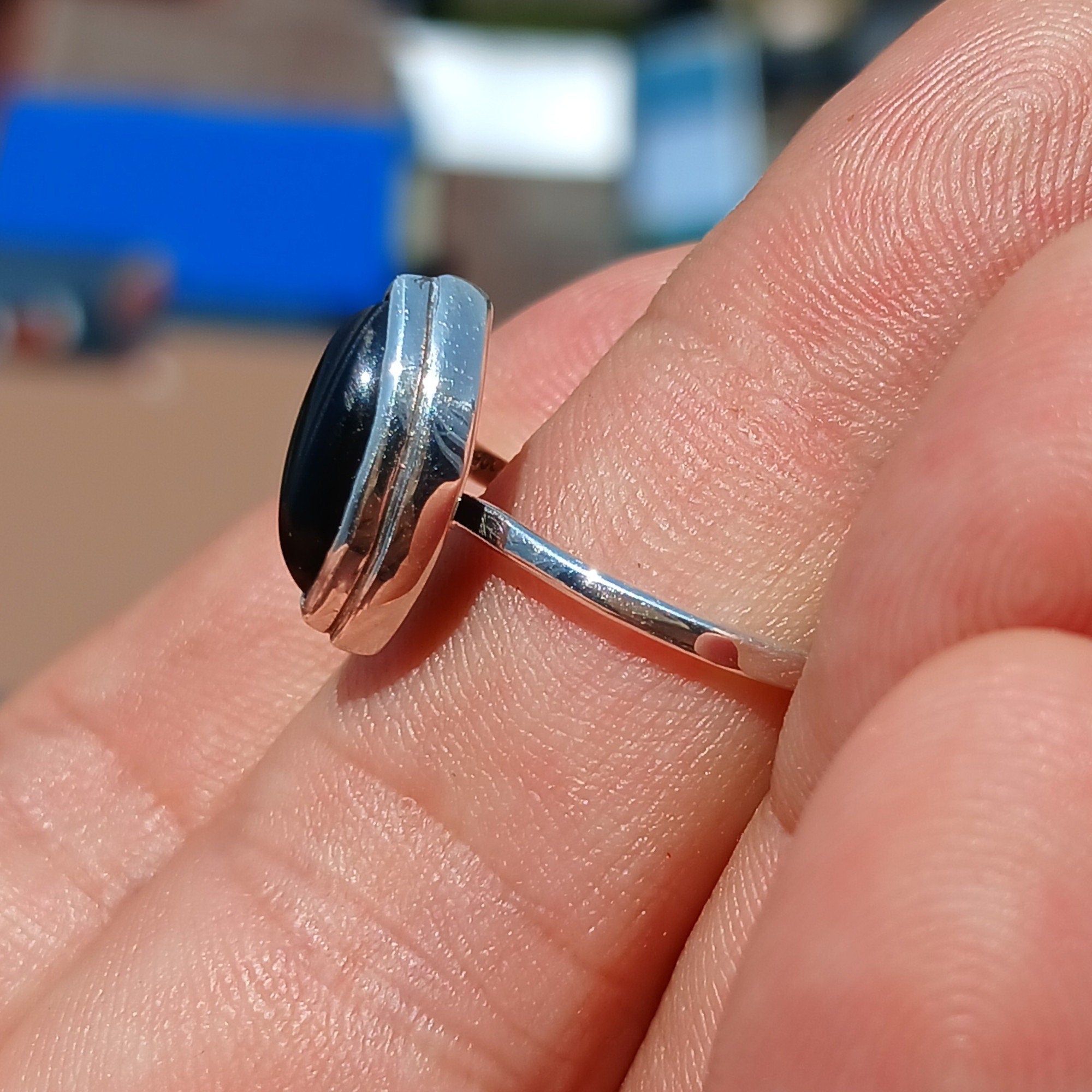 A stunning Black Onyx Ring featuring a marquise shaped gemstone set in polished sterling silver, showcasing elegance and minimalist design.