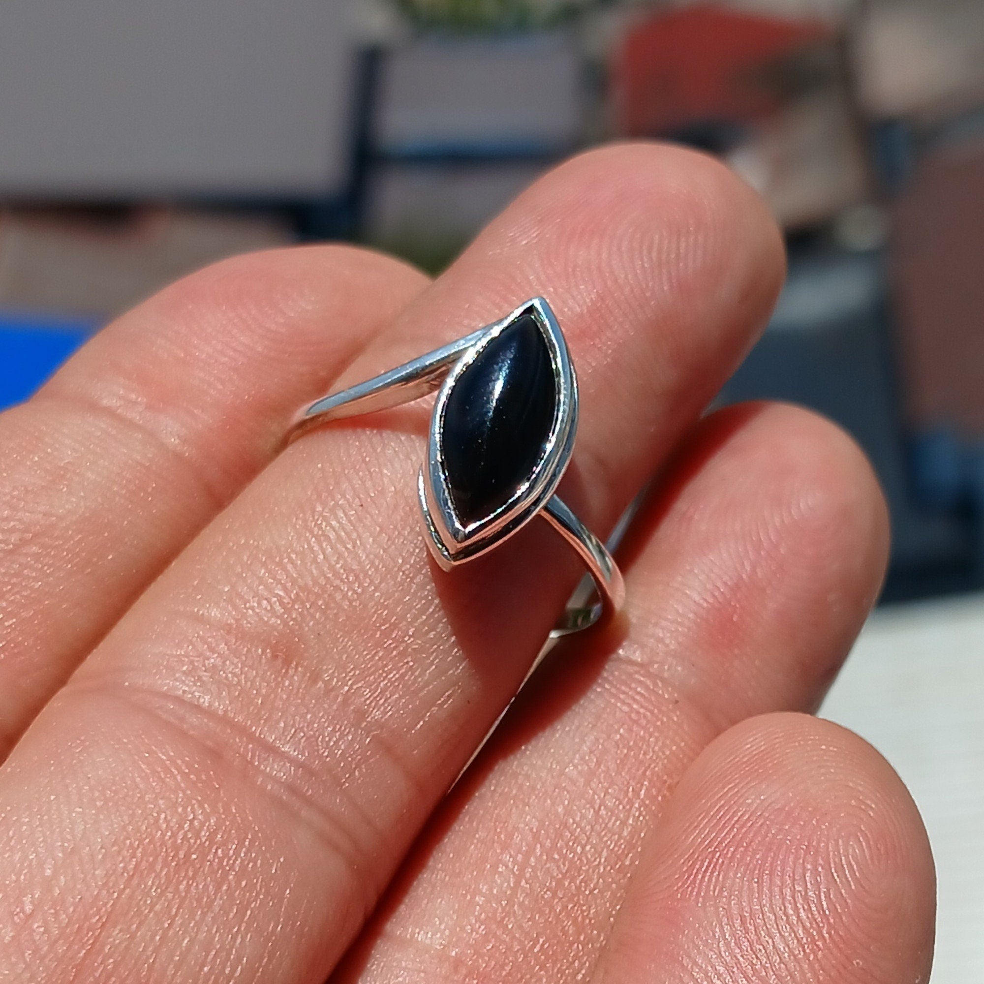 A stunning Black Onyx Ring featuring a marquise shaped gemstone set in polished sterling silver, showcasing elegance and minimalist design.