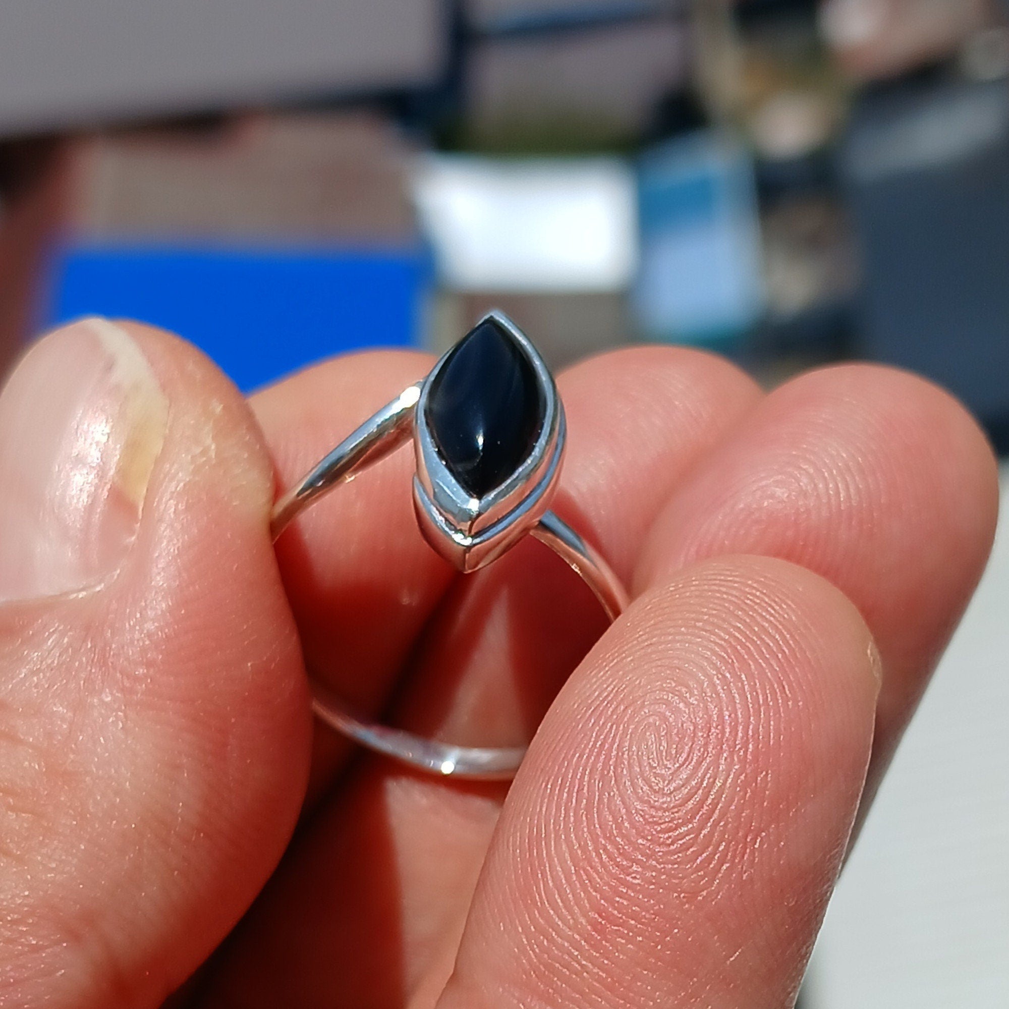 A stunning Black Onyx Ring featuring a marquise shaped gemstone set in polished sterling silver, showcasing elegance and minimalist design.