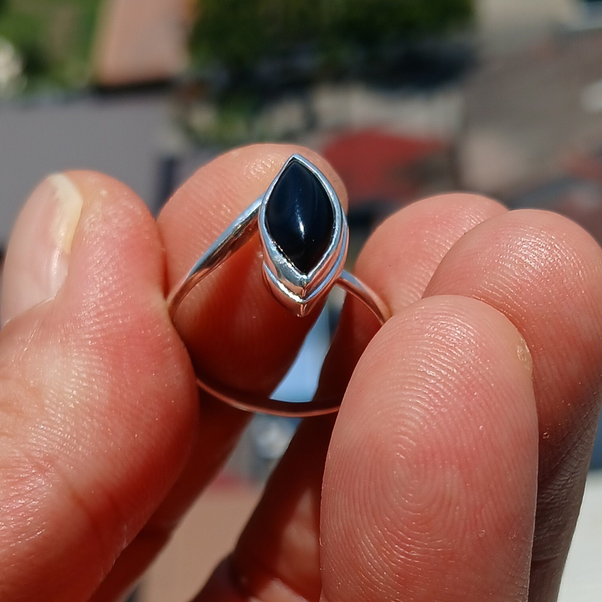 A stunning Black Onyx Ring featuring a marquise shaped gemstone set in polished sterling silver, showcasing elegance and minimalist design.