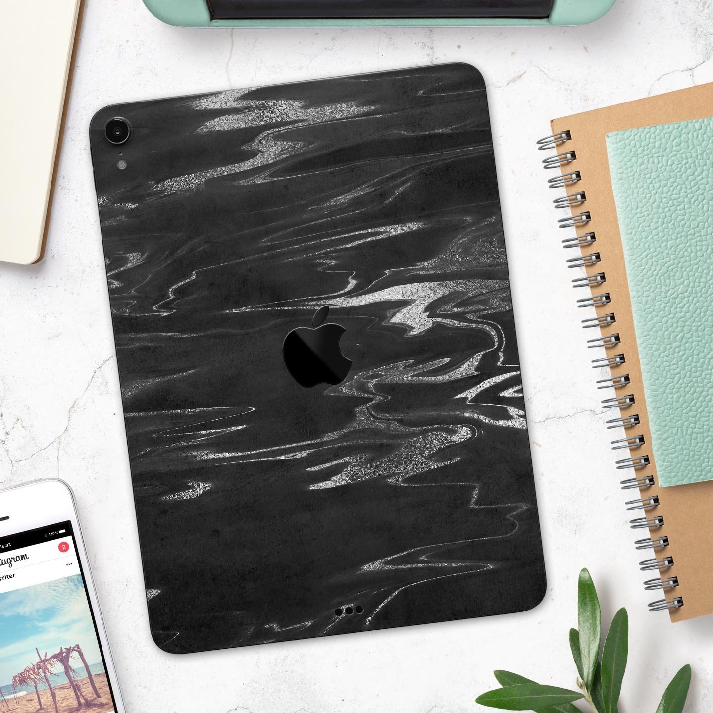 Black and silver marble swirl skin decal for Apple devices, showcasing a stylish design with premium finish.