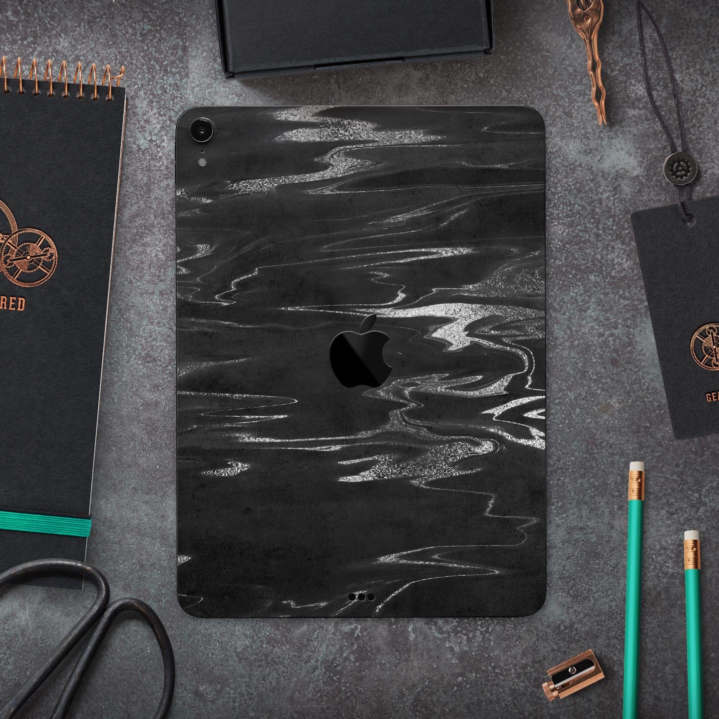 Black and silver marble swirl skin decal for Apple devices, showcasing a stylish design with premium finish.