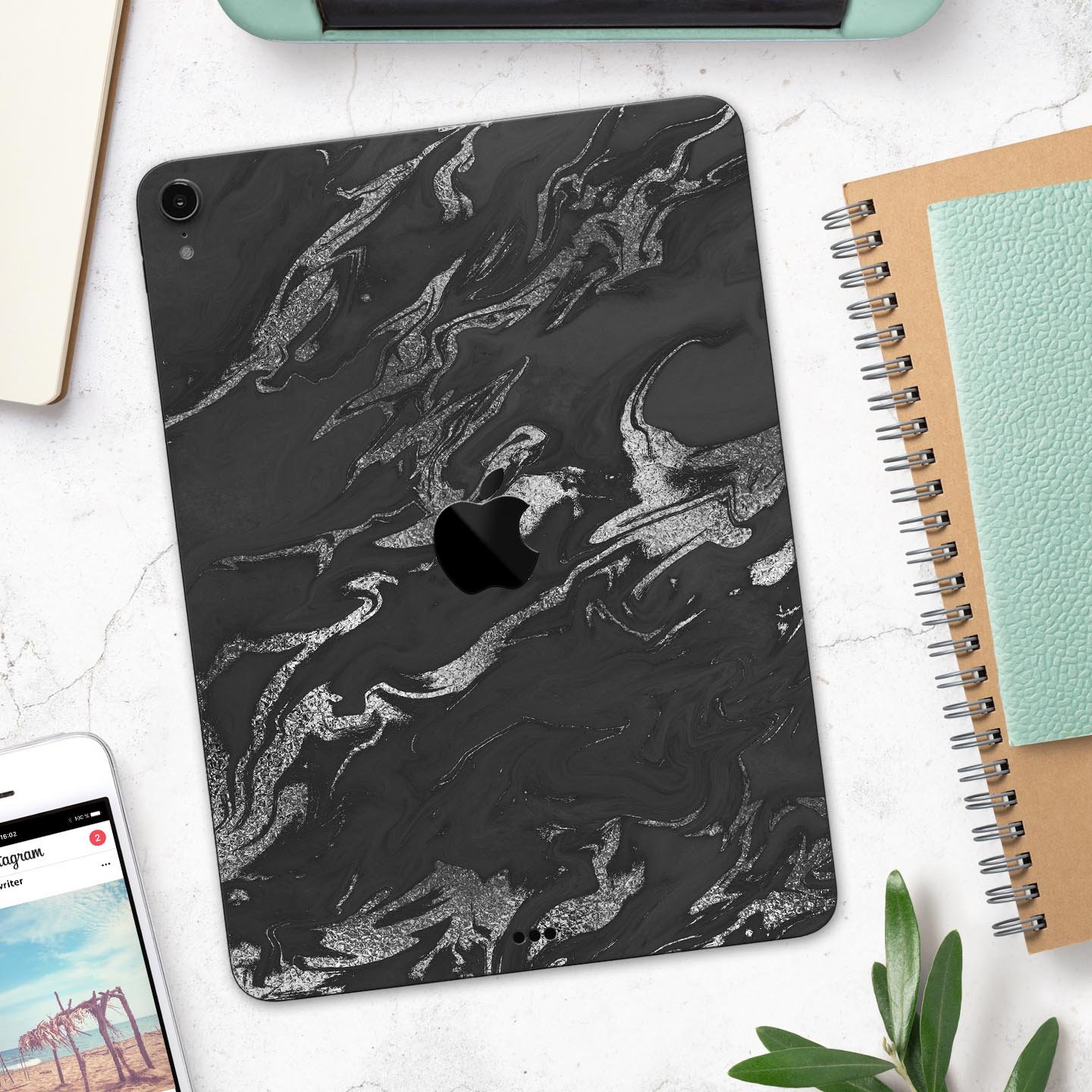 Black and silver marble swirl skin decal for Apple devices, showcasing a stylish design with ultra-thin protection.