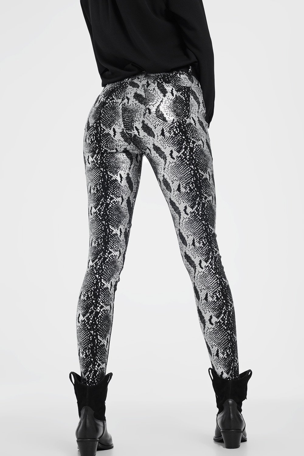 Black skinny shiny printed pants with zipper closure and pockets, showcasing a sleek and stylish design.