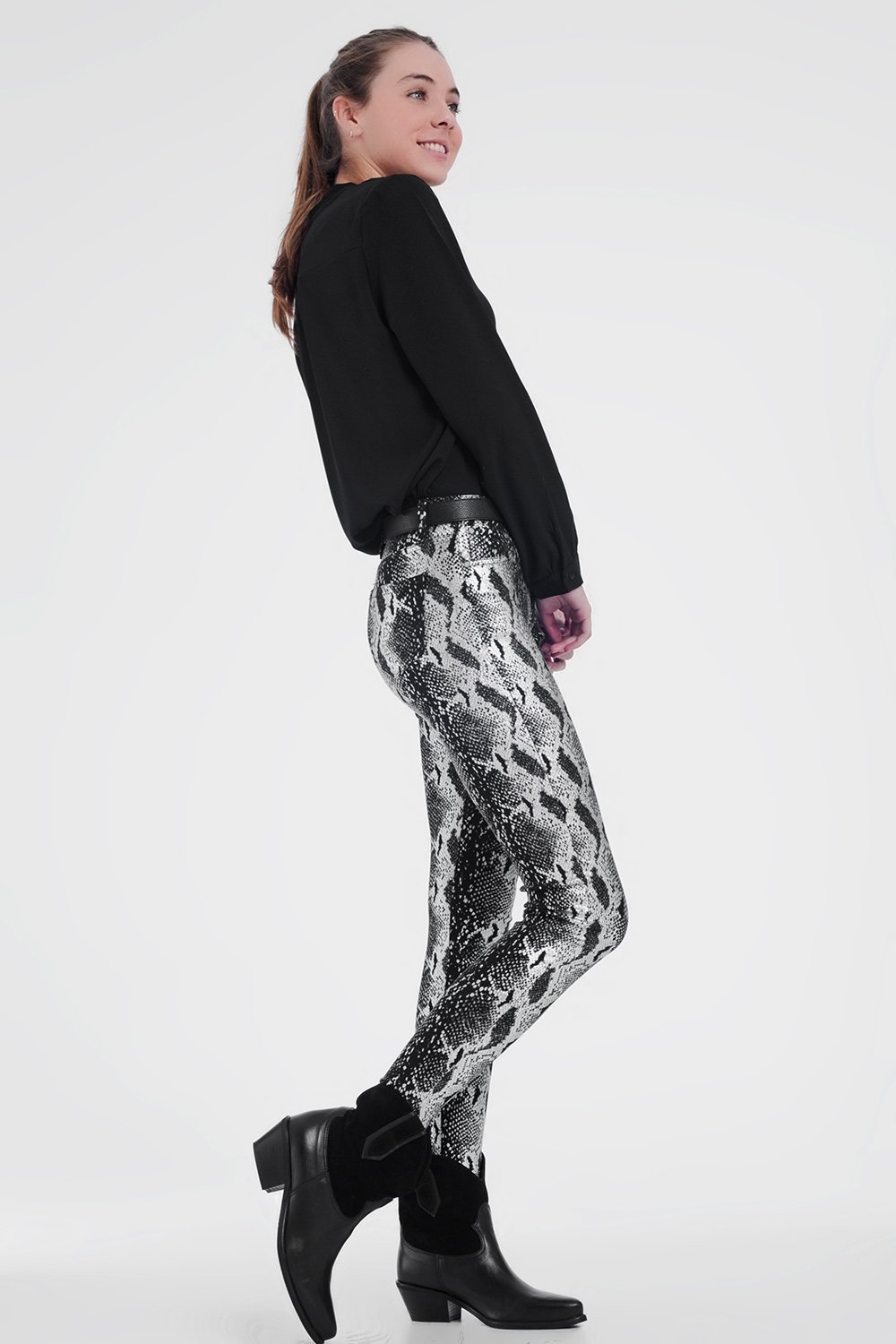 Black skinny shiny printed pants with zipper closure and pockets, showcasing a sleek and stylish design.