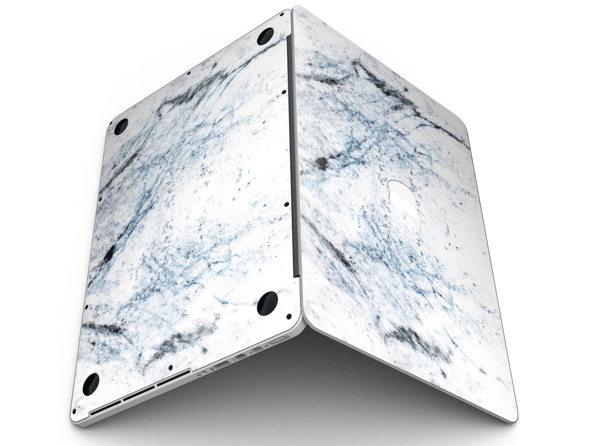Blue and black grunge vinyl skin on a MacBook Pro with Retina Display, showcasing a stylish design over a white marble surface.