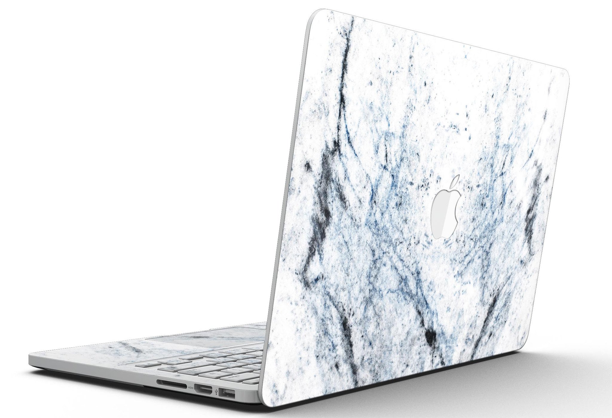 Blue and black grunge vinyl skin on a MacBook Pro with Retina Display, showcasing a stylish design over a white marble surface.