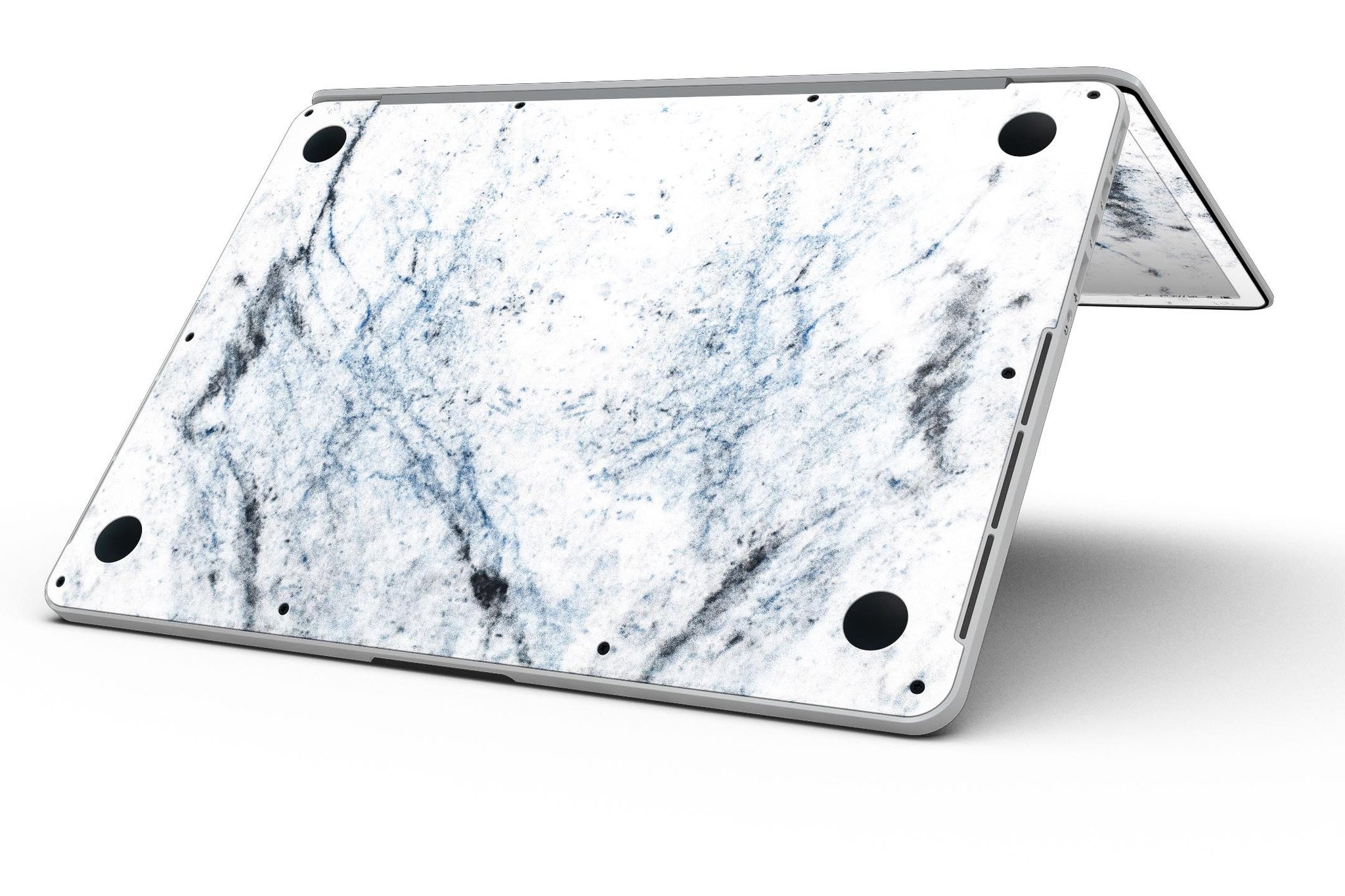 Blue and black grunge vinyl skin on a MacBook Pro with Retina Display, showcasing a stylish design over a white marble surface.