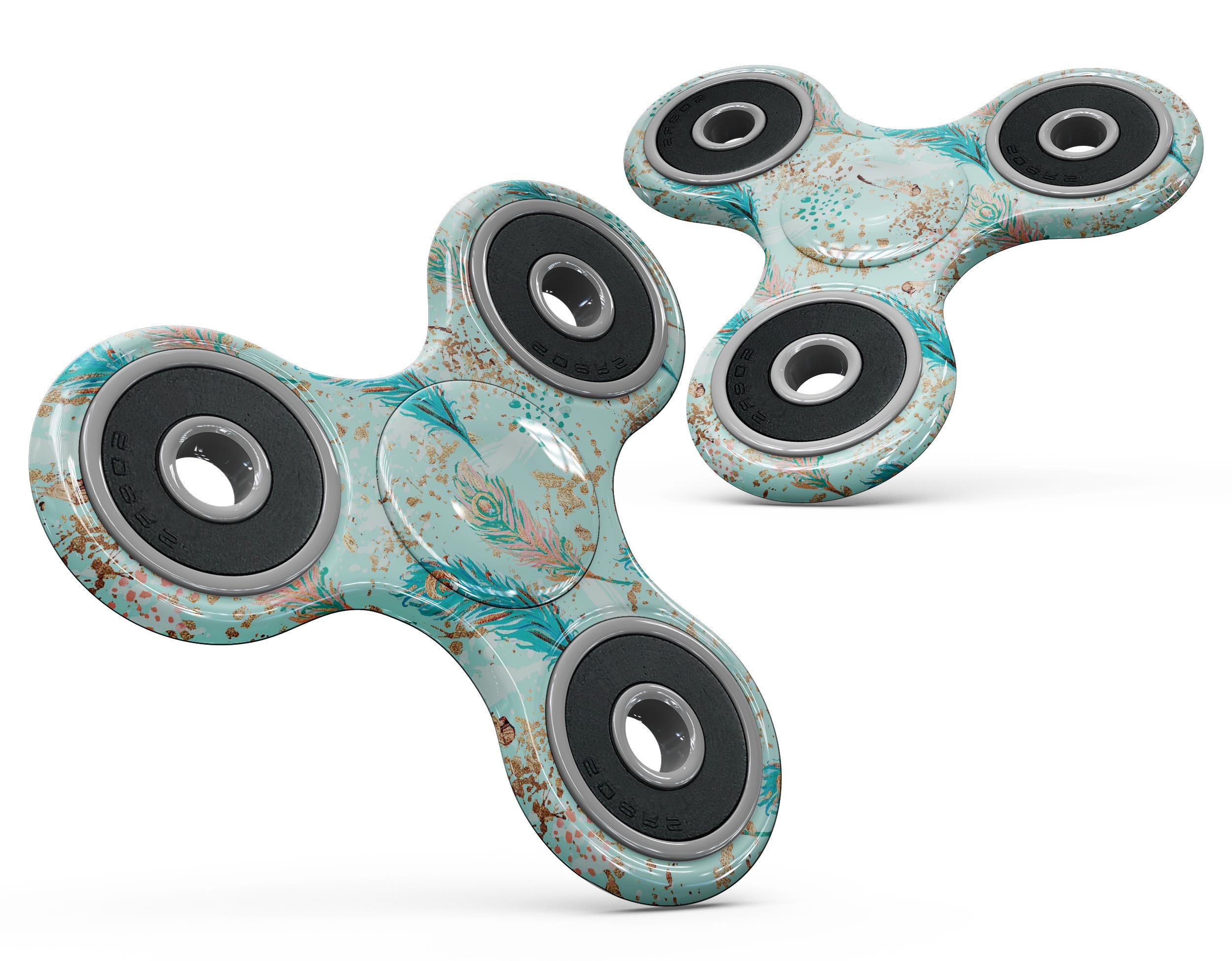 A vibrant fidget spinner skin featuring blue and coral feathers over teal strokes, designed for full-body coverage and protection.