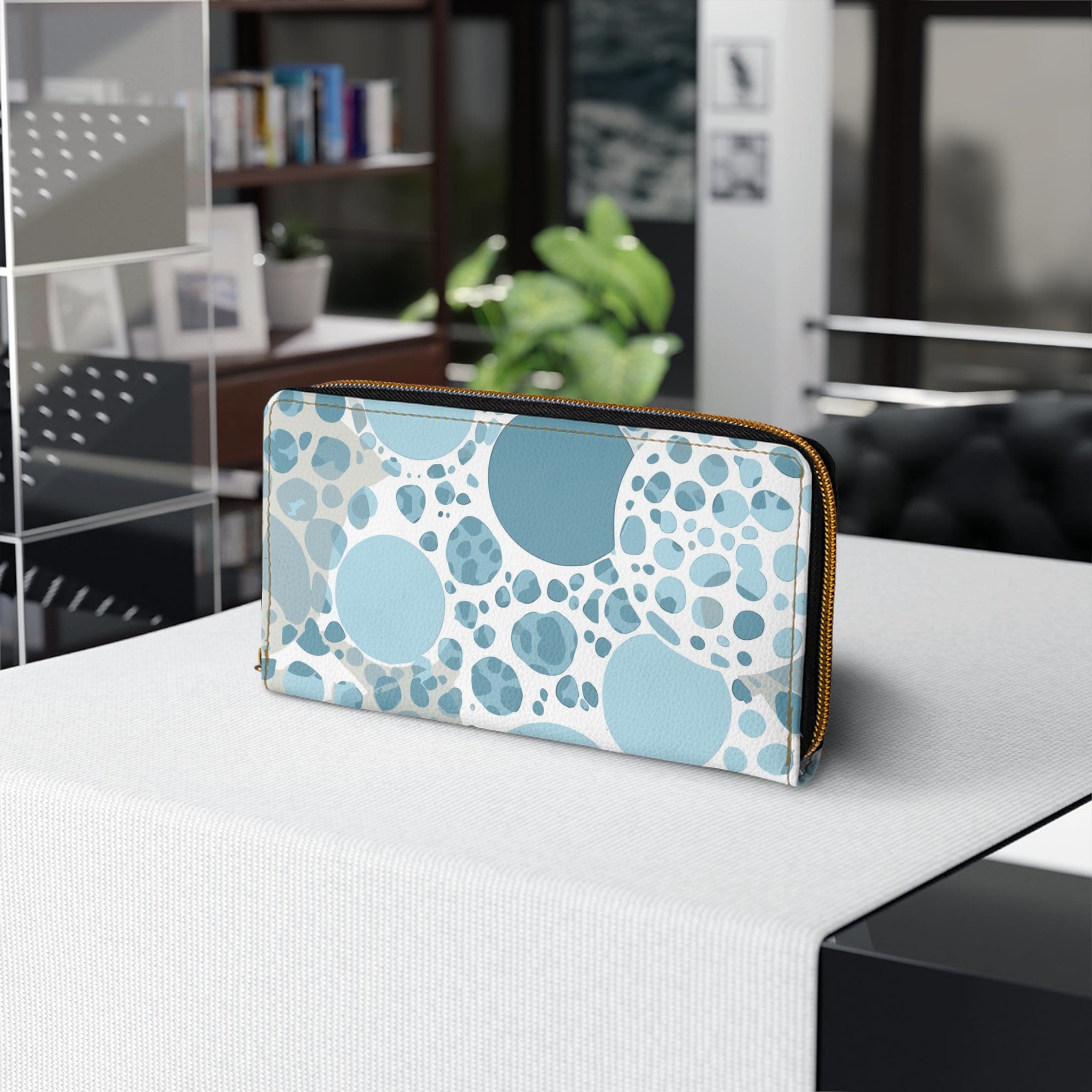 Blue and white women's zipper wallet featuring a circular spotted illustration, showcasing its stylish design and functional compartments.