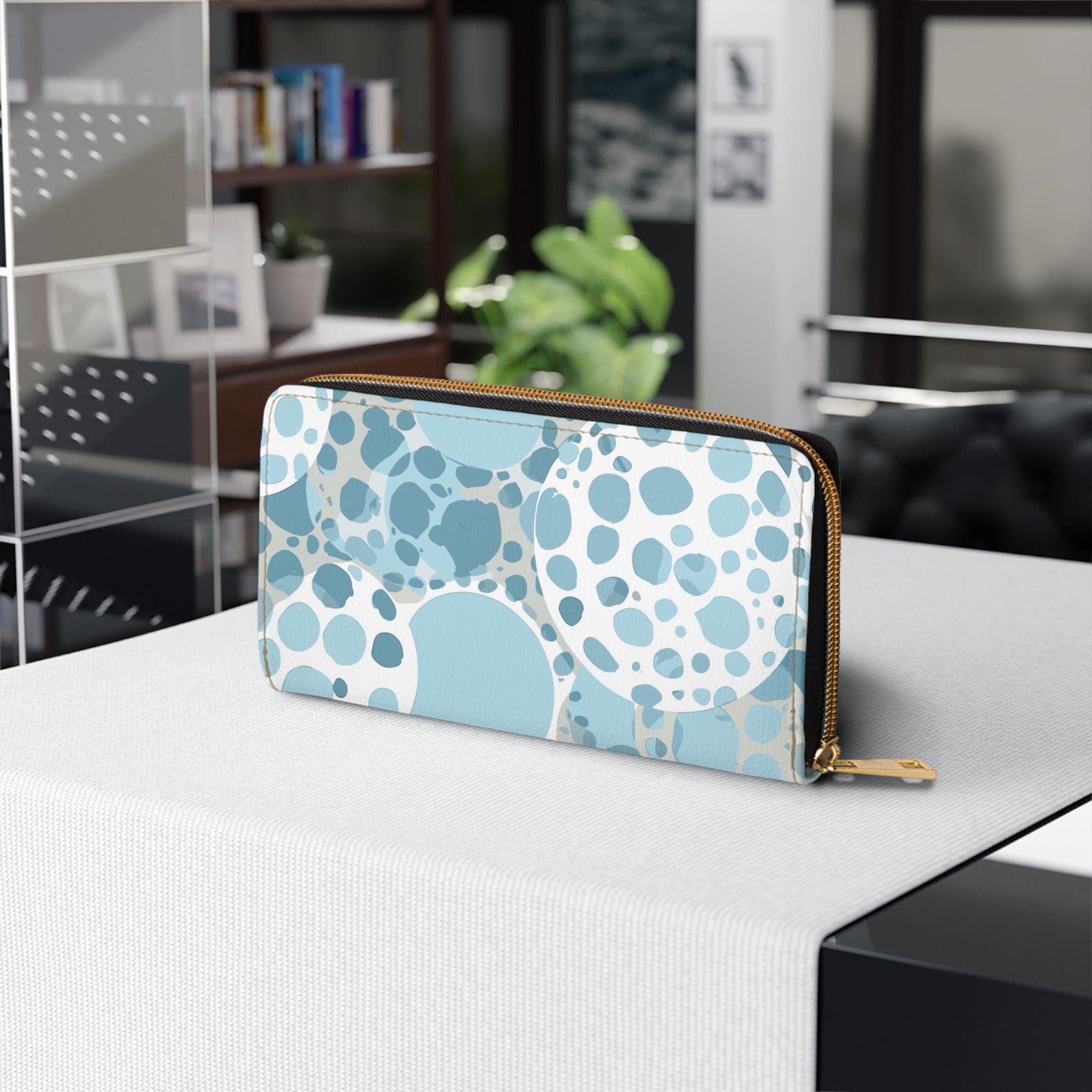 Blue and white women's zipper wallet featuring a circular spotted illustration, showcasing its stylish design and functional compartments.