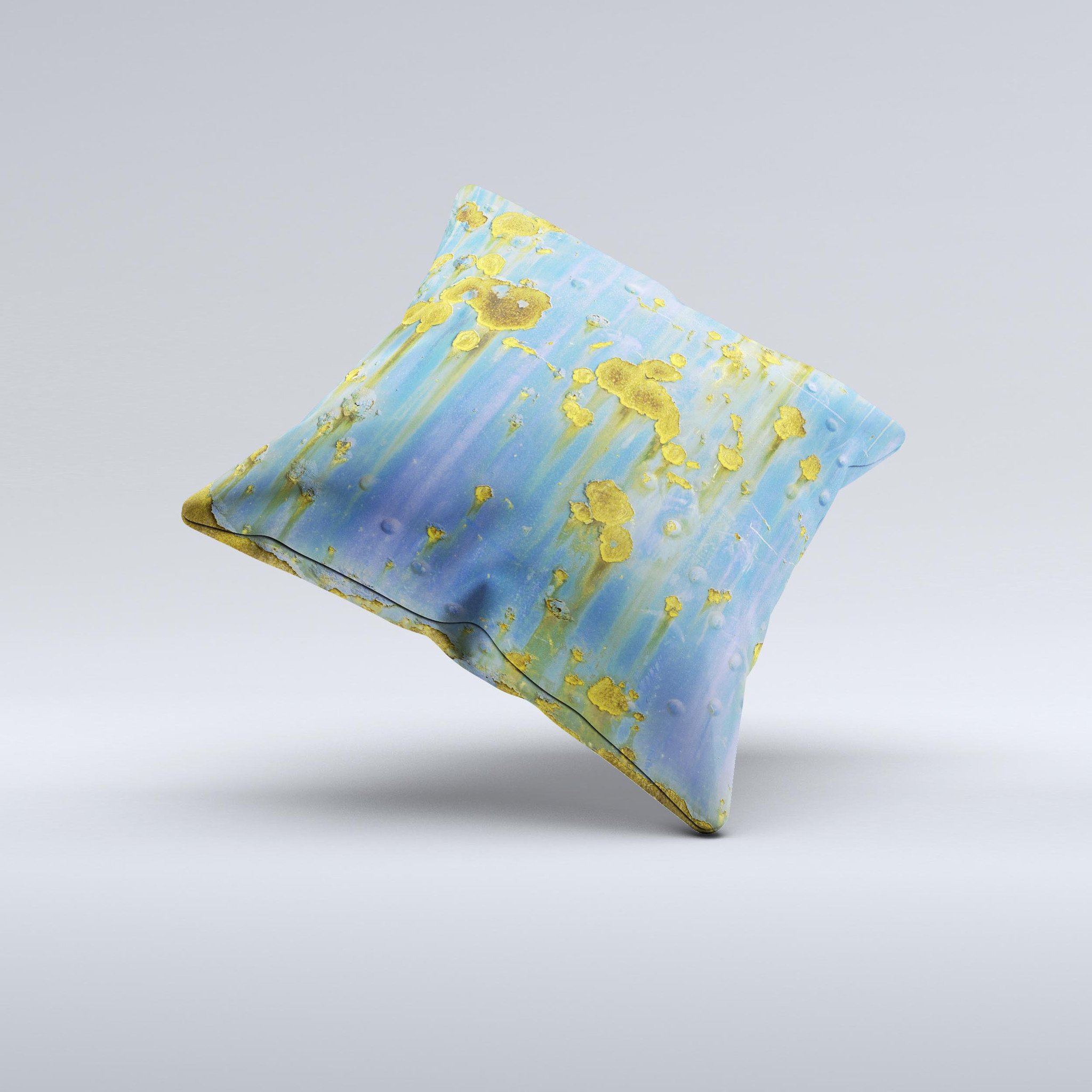 A decorative throw pillow featuring a blue metal background with gold rust accents, showcasing a unique ink-fuzed design, handcrafted in Virginia.