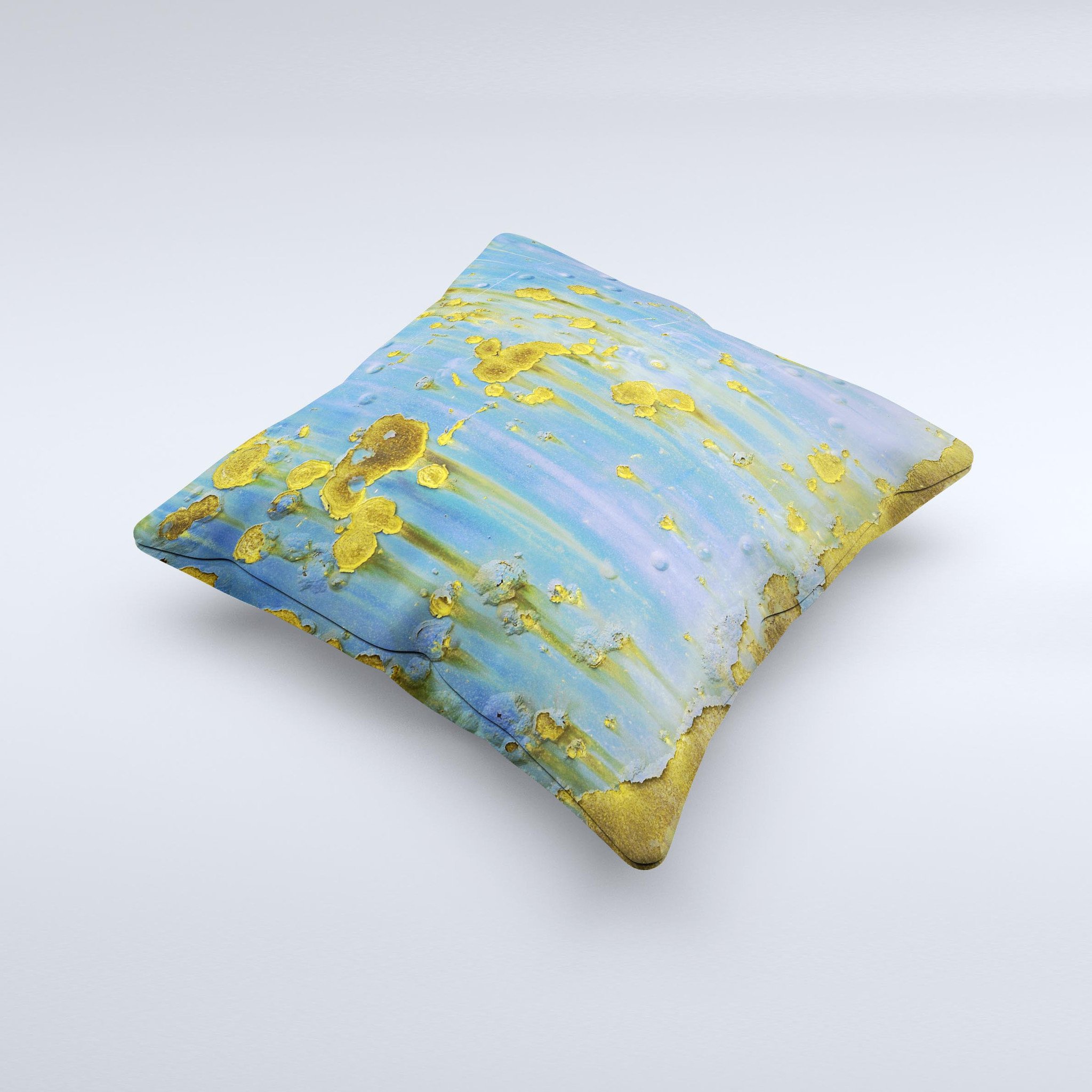 A decorative throw pillow featuring a blue metal background with gold rust accents, showcasing a unique ink-fuzed design, handcrafted in Virginia.