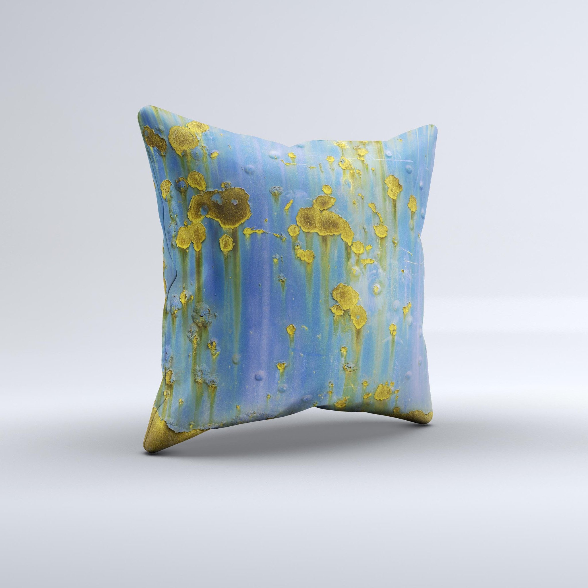 A decorative throw pillow featuring a blue metal background with gold rust accents, showcasing a unique ink-fuzed design, handcrafted in Virginia.